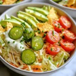 To create these tasty Pickle Ranch Chicken Slaw Bowls, you need a mix of fresh and flavorful ingredients. Here’s what you’ll need: - 2 cups shredded rotisserie chicken - 1 cup creamy buttermilk ranch dressing - 1 tablespoon dill pickle juice - 1 teaspoon garlic powder - 1/2 teaspoon onion powder - 4 cups coleslaw mix (a blend of shredded cabbage and carrots) - 1 cup diced dill pickles - 1/2 cup cherry tomatoes, halved - 1 ripe avocado, sliced - 1/4 cup fresh chives, finely chopped - Salt and freshly ground pepper to taste These items create a balance of textures and flavors. The chicken adds protein, while the dressing and pickles bring a tangy kick. If you want to jazz up your bowls, consider adding some optional ingredients: - Tortilla chips for added crunch - Sliced jalapeños for heat - Fresh herbs like cilantro or parsley for freshness These extras let you customize each bowl to suit your taste. You can easily mix and match to create your perfect dish. To make your cooking easier, gather these tools: - Large mixing bowl for the dressing - Separate mixing bowl for the slaw - Whisk for mixing the dressing - Serving bowls for presenting your meal Having the right tools helps streamline the cooking process. You’ll enjoy making these vibrant bowls even more! For the complete recipe, check out the Full Recipe. First, grab a large mixing bowl. This is where the magic starts. Whisk together the creamy buttermilk ranch dressing, dill pickle juice, garlic powder, onion powder, and a pinch of salt. Mix until everything is smooth. The dressing should taste tangy and rich. This blend will bring out the flavors in your chicken and slaw. Next, add the shredded rotisserie chicken to the dressing. Stir gently so each piece gets coated well. This step is important. It helps the chicken soak in all those tasty flavors. Let it sit for at least 15 minutes. You can leave it at room temperature. This short wait makes a big difference in taste. Now it’s time to put everything together. Take a serving bowl and add a generous handful of the coleslaw mix. Spread it out evenly. This will be the base. Spoon the pickle ranch chicken mixture on top of the slaw. Make sure it looks nice and layered. Then, add slices of avocado for creaminess. Top it off with fresh chives for extra flavor and color. If you like crunch, sprinkle some crushed tortilla chips on top. Serve these bowls right away and enjoy every bite of this fresh meal! For the complete recipe, check out the Full Recipe. To get the best flavor, use fresh herbs. Chives add a nice touch. You can also adjust the pickle juice for more tang. Always taste as you mix. If you like garlic, add more garlic powder. A sprinkle of salt and pepper enhances the dish. Don’t shy away from trying new spices, like smoked paprika. You can prepare the chicken and dressing a day before. Just store them in the fridge in separate containers. This saves time on busy days. You can also chop the veggies ahead of time. Keep the coleslaw mix fresh by covering it tightly. Assemble the bowls right before serving to maintain crunch. For a fun twist, try adding crushed tortilla chips on top. They give a perfect crunch. You can also add sliced jalapeños for some heat. Serving the bowls in colorful dishes makes them pop. A sprinkle of sesame seeds can add a nice touch too. You might even drizzle a bit of extra ranch dressing for added flavor. For the full recipe, check out the details above. {{image_4}} You can switch up the protein in these bowls. Use turkey, tofu, or chickpeas. Any of these will add flavor and texture. For a fun twist, try grilled shrimp or seasoned beef. Each option brings a unique taste to the dish. If you have dietary needs, worry not! Use dairy-free ranch dressing for a vegan option. You can also swap the chicken for a plant-based protein. Make sure to check that any dressing or condiments fit your needs. It’s easy to adapt this recipe to fit many diets. Seasonal veggies can elevate your bowls. In spring, add fresh peas or radishes. Summer is great for corn and fresh herbs. In fall, consider roasted squash or apples for sweetness. Winter can bring hearty greens like kale or Brussels sprouts. Each season offers new flavors to explore. To keep your Pickle Ranch Chicken Slaw Bowls fresh, store them in an airtight container. This helps seal in flavors and prevents spoilage. I suggest separating the chicken from the slaw for best results. The chicken can stay moist while the slaw stays crisp. If you add avocado, it's best to eat that right away. If you must store it, sprinkle a bit of lemon juice to slow browning. When stored properly, your bowls can last about 3 days in the fridge. After that, the ingredients may start to lose their texture and flavor. Always check for any signs of spoilage, like sour smells or discoloration. If you see or smell something off, it’s better to be safe and toss it. You can freeze the chicken part of the dish for longer storage. Just place it in a freezer-safe bag or container. It lasts about 2-3 months in the freezer. When ready to eat, thaw it in the fridge overnight. Reheat it gently in a pan or microwave. I advise against freezing the slaw since it can become mushy when thawed. For the best taste, enjoy your Pickle Ranch Chicken Slaw Bowls fresh! Yes, you can use other dressings. Try a vinaigrette for a lighter taste. A yogurt-based dressing adds creaminess without the heaviness. You can also mix ranch with mustard for a zesty twist. Just make sure the dressing balances the flavors in the bowl. To make this dish vegetarian, swap the chicken for chickpeas or tofu. Both options soak up the dressing well. Use a plant-based ranch dressing or make your own with yogurt, herbs, and spices. This way, you keep the flavors bright and fresh. These bowls pair well with tortilla chips for crunch. You can also add a side of corn on the cob for sweetness. Fresh fruit salad brings a nice balance too. If you want something warm, consider grilled veggies or a light soup. Each option complements the bright flavors of the slaw bowls. For the full recipe, check out the earlier section. This blog post covered all you need for Pickle Ranch Chicken Slaw Bowls. We explored the main ingredients and optional flavors. You learned how to prepare the dressing and marinate the chicken. I shared tips for seasoning and ideas for meal prep. We also discussed variations and how to store leftovers. Cooking can be fun, creative, and rewarding. Enjoy your tasty bowls, and don’t be afraid to make them your own!