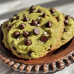 To make avocado chocolate chip cookies, gather these simple items: - 1 ripe avocado, thoroughly mashed - 1/2 cup packed brown sugar - 1/4 cup granulated sugar - 1/4 cup unsalted butter, melted and slightly cooled - 1 teaspoon pure vanilla extract - 1 large egg, room temperature - 1 cup all-purpose flour - 1/2 teaspoon baking soda - 1/4 teaspoon fine sea salt - 1 cup semisweet chocolate chips These ingredients create a tasty cookie with a twist. If you don’t have some items, here are good swaps: - Avocado: Use 1/2 cup unsweetened applesauce. This keeps it moist. - Butter: Coconut oil works well. It adds a hint of flavor. - Brown Sugar: Use coconut sugar for a lower glycemic option. - All-purpose flour: Try oat flour for a gluten-free choice. These substitutes can change the flavor and texture but still taste great. These cookies are not just yummy; they also pack some nutrition. Here’s a quick look: - Calories: About 120 per cookie - Fat: 6g (mostly healthy fats from avocado) - Carbohydrates: 16g - Protein: 1g - Fiber: 1g Using avocado adds healthy fats and fiber. You can enjoy a treat without feeling guilty. For the full recipe, check out my detailed guide. 1. Preheat your oven to 350°F (175°C). This is key for even baking. 2. Line a baking sheet with parchment paper. This makes cleanup easy and prevents sticking. 3. In a large bowl, mash one ripe avocado until smooth. It should be creamy. 4. Add 1/2 cup brown sugar, 1/4 cup granulated sugar, 1/4 cup melted butter, and 1 teaspoon vanilla extract. Mix until smooth and creamy. 5. Crack one large egg into the bowl. Whisk until the mix is fluffy and well combined. 6. In another bowl, mix 1 cup flour, 1/2 teaspoon baking soda, and 1/4 teaspoon salt. This helps the cookies rise. 7. Slowly add the dry mix to the wet mix. Stir gently until combined. A few lumps are fine. 8. Fold in 1 cup of chocolate chips with a spatula. Make sure they spread evenly in the dough. 1. Use a tablespoon or cookie scoop to place rounded dough on the baking sheet. Space them about 2 inches apart. 2. Bake in the preheated oven for 10-12 minutes. Look for golden edges and soft centers. 3. Once done, take the cookies out of the oven. Let them sit on the sheet for about 5 minutes. This helps them firm up. 1. Transfer the cookies to a wire rack to cool completely. 2. Serve the cookies in a jar or on a decorative plate. 3. For a special touch, sprinkle them with sea salt before serving. This enhances the chocolate flavor. Follow the [Full Recipe] to make these tasty avocado chocolate chip cookies! - Use a ripe avocado. It should feel soft to the touch. - Measure your ingredients accurately for the best results. - Mix the wet ingredients until creamy for a smooth dough. - Don’t overmix when adding dry ingredients; a few lumps are okay. - Space cookies at least 2 inches apart on the baking sheet. - Using unripe avocados can lead to a gritty texture. - Overbaking makes cookies hard instead of soft and chewy. - Forgetting to let the melted butter cool can change the dough. - Not cooling cookies on a wire rack can make them soggy. - Store cookies in an airtight container to keep them fresh. - For longer storage, freeze the cookies in a freezer bag. - To reheat, warm cookies in the oven at 300°F (150°C) for 5-7 minutes. - Enjoy them warm for that fresh-baked taste! For the full recipe, check out the details above. {{image_4}} You can make vegan avocado chocolate chip cookies easily. Replace the egg with a flax egg. To make a flax egg, mix 1 tablespoon of ground flaxseed with 2.5 tablespoons of water. Let it sit for 5 minutes until it thickens. Use the same method as the original recipe. The cookies will still be soft and tasty. If you want gluten-free cookies, swap all-purpose flour for almond or oat flour. Both options work well. Just ensure they are finely ground. Adjust the amount slightly, as these flours absorb moisture differently. The taste will change, but the cookies will remain delicious. Get creative with your cookies! You can add nuts like walnuts or pecans for crunch. Dried fruit, like cranberries or raisins, adds a sweet touch. For a fun twist, try adding a teaspoon of instant coffee or a pinch of cinnamon. Each choice adds a unique flavor to your cookies. To keep your avocado chocolate chip cookies fresh, use an airtight container. Place parchment paper between layers to prevent sticking. Store them at room temperature for up to three days. If you want to keep them longer, consider refrigerating them. Just let them warm up to room temp before eating. You can freeze the cookie dough for later use. Scoop the dough onto a baking sheet and freeze until firm. Once solid, transfer the dough balls to a zip-top bag. They will last in the freezer for up to three months. When you’re ready to bake, just take them out and let them thaw for about 30 minutes before baking. Baked cookies can last about a week in an airtight container at room temperature. If you notice them getting hard, pop them in the microwave for a few seconds. This will soften them up again. For the best taste, try to eat them within a few days. Enjoy your delicious treats from the Full Recipe! Yes, you can use ripe avocados for this recipe. Ripe avocados add a smooth texture and rich taste. Look for avocados that yield slightly when you press them. This softness means they are ready to mash. The ripeness helps make the cookies moist and flavorful. You can also mash the avocado with a fork or a blender for a creamy mix. To know when the cookies are done, check the edges. They should be golden brown. The centers may look soft and slightly undercooked. This is perfect! They will firm up as they cool. For best results, set a timer for 10-12 minutes. Keep an eye on them to avoid burning. If your cookies turn hard, you can soften them easily. Place a slice of bread in the container with the cookies. The moisture from the bread will help them soften. You can also microwave cookies for a few seconds. This will warm them up and make them soft again. Store leftover cookies in an airtight container to keep them fresh longer. This blog post covered key ingredients, step-by-step instructions, and tips for making cookies. You learned about ingredient substitutes and nutrition too. I shared variations like vegan and gluten-free options. Storing and reheating cookies is essential to enjoy them longer. Remember the common mistakes to avoid for perfect cookies every time. Use the FAQ section for quick answers. Try these tips and recipes to create delicious cookies that everyone loves. Enjoy your baking adventure and happy eating!
