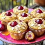 To make Cherry Almond Protein Muffins, you need simple and healthy ingredients. Here’s a list for you: - 1 cup almond flour - 1/2 cup rolled oats - 1/2 cup protein powder (vanilla or unflavored) - 1/4 cup honey or maple syrup - 1/2 cup plain Greek yogurt - 2 large eggs - 1/2 cup unsweetened almond milk - 1 teaspoon baking powder - 1/2 teaspoon baking soda - 1/2 teaspoon salt - 1 cup fresh or frozen cherries, pitted and halved - 1/4 cup sliced almonds (for topping) - 1 teaspoon almond extract Each ingredient plays a key role in making these muffins tasty and nutritious. Almond flour gives a nutty flavor and a great texture. Rolled oats add heartiness and health benefits. Protein powder boosts the protein content, making these muffins perfect for a snack or breakfast. Using honey or maple syrup adds sweetness, while Greek yogurt keeps the muffins moist. The eggs help bind everything together, giving structure. Almond milk keeps the muffins light and adds a hint of almond flavor. Baking powder and baking soda make the muffins rise, resulting in fluffy bites. Cherries bring a burst of color and flavor, while sliced almonds on top add a delightful crunch. The almond extract enhances the nutty taste, tying all the flavors together. You can find the full recipe in the article to guide you step by step. Happy baking! Set your oven temperature to 350°F (175°C). Line a muffin tin with paper liners or grease each cup lightly. This helps the muffins come out easily after baking. In a large bowl, combine the almond flour, rolled oats, protein powder, baking powder, baking soda, and salt. Use a whisk to stir these ingredients well. Mixing them well ensures that your muffins rise evenly. In another bowl, whisk together the honey (or maple syrup), Greek yogurt, eggs, almond milk, and almond extract. Mix until it is smooth and creamy. This step adds moisture and flavor to your muffins. Gradually add the wet mixture to the dry mixture. Stir gently with a spatula until just combined. Be careful not to overmix the batter, as this can make the muffins tough. Gently fold the halved cherries into the batter. This adds bursts of flavor throughout each muffin. Then, fill each muffin cup about two-thirds full with the batter. This allows space for the muffins to rise. Place the muffin tin in the oven and bake for 18-20 minutes. The muffins should be golden on top. You can check for doneness by inserting a toothpick in the center; it should come out clean. Let the muffins cool in the pan for 5 minutes before transferring them to a wire rack. To make the best cherry almond protein muffins, watch your baking time. I suggest checking them at the 18-minute mark. If they look golden and a toothpick comes out clean, they are ready. Overbaking can dry out the muffins, so keep a close eye on them. After baking, let the muffins cool in the pan for five minutes. This step helps them firm up and gives you the right texture. Then, move them to a wire rack to cool completely. If you don’t have almond flour, you can use oat flour or whole wheat flour. They work well and will still taste great. For protein powder, you can try using a plant-based option or even a different flavor. If you need a non-dairy version, swap Greek yogurt for coconut yogurt or silken tofu. For almond milk, you can use soy milk or oat milk. These changes will still keep your muffins tasty and nutritious. Want to kick up the flavor? You can add a pinch of cinnamon or nutmeg to the batter. Both spices pair well with the cherries and almonds. You might also try adding a splash of vanilla extract for extra sweetness. If you enjoy a hint of citrus, a bit of lemon zest can brighten the taste. These simple additions can make your muffins even more delightful. Check out the full recipe to get started on your delicious cherry almond protein muffins! {{image_4}} You can play with flavors in these muffins. Dark chocolate chips add a rich touch. You can mix in some unsweetened coconut for a tropical twist. If you want to switch up the fruit, try using blueberries or raspberries. Both fruits pair well with almonds and give a fresh taste. You can also use dried cherries for a chewiness that works great in muffins. To make these muffins vegan, swap the eggs for flax eggs. Just mix one tablespoon of ground flaxseed with three tablespoons of water and let it sit for five minutes. Use plant-based yogurt instead of Greek yogurt. Maple syrup is a good choice to keep it sweet. You can still enjoy the same tasty muffins without animal products. If you want to cut back on sugar, reduce the honey or maple syrup. You can try using mashed bananas or unsweetened applesauce. Both will keep your muffins moist and sweet. Just remember to balance the flavors so you still enjoy every bite. Use spices like cinnamon to enhance the taste without adding more sugar. For the full recipe, check out the [Full Recipe] section above! To keep your Cherry Almond Protein Muffins fresh at room temperature, place them in an airtight container. This helps to keep moisture in and air out. Store them for up to three days. If you live in a warm area, keep them in a cool, dry place. Avoid direct sunlight, as it can dry them out. These muffins taste best when fresh, so enjoy them soon after baking. For long-term storage, freezing is the best option. Allow the muffins to cool completely before freezing. Wrap each muffin tightly in plastic wrap or aluminum foil. Then, place them in a freezer-safe bag or container. This method prevents freezer burn and helps preserve flavor. You can freeze them for up to three months. When ready to eat, simply thaw them in the fridge overnight or leave them at room temperature for a few hours. To enjoy your muffins warm, you can easily reheat them. Preheat your oven to 350°F (175°C). Place the muffins on a baking sheet and warm them for about 10 minutes. This method helps restore their soft texture. You can also use the microwave for a quick fix. Heat each muffin for 15-20 seconds. Just be careful not to overheat, as that can make them dry. For the full recipe, check out the delicious Cherry Almond Protein Muffins! Yes, you can use frozen cherries. They work just as well as fresh cherries. Just make sure to thaw them first and drain any extra liquid. This keeps the batter from becoming too wet. Frozen cherries can add a nice burst of flavor, and they are often just as nutritious as fresh ones. To check if your muffins are done, look for a golden top. Insert a toothpick into the center of a muffin. If it comes out clean or with a few crumbs, the muffins are ready. They should feel firm to the touch. If they are still wet, bake them for a few more minutes. Each muffin has about 150 calories. They are rich in protein and fiber. The almond flour and Greek yogurt add healthy fats and nutrients. Plus, cherries provide antioxidants. This makes them a tasty and nutritious snack. Enjoy these muffins guilt-free, knowing they are good for you! For the complete recipe, check the Full Recipe section. This blog post covers a simple and tasty cherry almond protein muffin recipe. You learned about the key ingredients and steps to make them. I shared tips for baking success, ingredient swaps, and ways to customize the recipe. Muffins can be fun and flexible. Whether you want to make them vegan or low-sugar, it's easy! Always store them well to keep their flavor fresh. Enjoy cooking, and have fun trying different variations. Your kitchen adventures can lead to yummy treats!