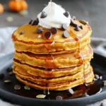 To make delicious pumpkin chocolate chip pancakes, you need specific ingredients that come together perfectly. Here’s what you’ll need: - 1 cup all-purpose flour - 1/2 cup canned pumpkin puree - 2 tablespoons granulated sugar - 2 teaspoons baking powder - 1/2 teaspoon baking soda - 1/2 teaspoon ground cinnamon - 1/4 teaspoon ground nutmeg - 1/4 teaspoon salt - 1 cup milk (dairy or non-dairy) - 1 large egg - 3 tablespoons melted butter or coconut oil - 1/2 cup semi-sweet chocolate chips These ingredients create a fluffy and flavorful pancake. The pumpkin puree adds moisture and a warm taste. The chocolate chips bring sweetness, making each bite a treat. Using spices like cinnamon and nutmeg gives a cozy fall flavor. You can find the full recipe for guidance on how to combine these ingredients for the best results. Start by gathering your dry ingredients. In a large bowl, combine: - 1 cup all-purpose flour - 2 tablespoons granulated sugar - 2 teaspoons baking powder - 1/2 teaspoon baking soda - 1/2 teaspoon ground cinnamon - 1/4 teaspoon ground nutmeg - 1/4 teaspoon salt Whisk these together well. You want to make sure there are no clumps. This mix gives the pancakes their nice rise and flavor. Next, it's time for the wet ingredients. In a separate bowl, add: - 1/2 cup canned pumpkin puree - 1 cup milk (you can use dairy or non-dairy) - 1 large egg - 3 tablespoons melted butter or coconut oil Use a whisk to mix these until smooth. The pumpkin makes the pancakes moist and tasty. Now, we bring it all together. Gradually pour the wet mix into the dry mix. Stir gently until just combined. It’s okay if there are a few lumps. Then, fold in: - 1/2 cup semi-sweet chocolate chips The chocolate chips add a sweet surprise in every bite! Preheat a non-stick skillet over medium heat. Lightly grease it with butter or oil. When hot, pour about 1/4 cup of batter for each pancake. Cook until bubbles form on top, about 2-3 minutes. Flip the pancakes carefully. Cook for another 2-3 minutes until golden brown. Remove the pancakes and keep them warm. Repeat with the rest of the batter. Enjoy your delightful Pumpkin Chocolate Chip Pancakes! For the full recipe, check the details provided earlier. To get fluffy pancakes, avoid overmixing the batter. When you mix too much, the pancakes get tough. Mix just until you see no dry flour. It’s okay if the batter has some lumps. This keeps the pancakes soft and light. Get your skillet hot before cooking. Heat it on medium heat for a few minutes. To test, drop a little water on the skillet. If it sizzles, it's ready! Lightly grease the skillet with butter or oil. This helps prevent sticking and gives a nice, golden color. To serve, stack the warm pancakes on a plate. Drizzle with maple syrup for a sweet touch. Add extra semi-sweet chocolate chips on top for fun. You can also sprinkle toasted pumpkin seeds for crunch. For a treat, add a dollop of whipped cream. This makes each bite even more special. {{image_4}} If you want a gluten-free option, swap the all-purpose flour for a gluten-free blend. Look for a brand that contains xanthan gum. This helps keep the pancakes fluffy. Follow the same measurements as the original recipe. You won't lose any flavor, and they will still taste great! For a dairy-free option, use plant-based milk and butter. Almond milk or oat milk work well in this recipe. You can also substitute regular butter with coconut oil. This change keeps the pancakes moist and delicious without dairy. They will still have that rich pumpkin flavor. You can make these pancakes even better with some fun extras! Adding nuts like walnuts or pecans gives a nice crunch. You can also try different types of chocolate. Dark chocolate chips or white chocolate can change the taste. Get creative and mix in your favorite flavors. Each bite will surprise you with delight! For the full recipe, check out the detailed instructions above. Enjoy your cooking! To keep your leftover pumpkin chocolate chip pancakes fresh, store them in an airtight container. You can refrigerate them for up to four days. If you want to keep them longer, freeze them. Place wax paper between each pancake to prevent sticking. Then, put them in a freezer-safe bag or container. This way, they stay fresh for up to three months. When you're ready to enjoy your pancakes again, reheating is simple. For the best results, use a skillet. Heat it over medium heat. Place the pancakes in the skillet for about 2 minutes on each side. You can also use a microwave. Heat them for 20 to 30 seconds. Just be careful not to overheat them, as they can become tough. In the fridge, your pancakes will last about four days. If frozen, they can last up to three months. However, for the best taste and quality, try to eat them sooner. It’s always nice to enjoy them fresh! Yes, you can make the batter ahead. Store it in the fridge. Use an airtight container for best results. The batter stays fresh for about 24 hours. Just remember to stir it gently before cooking. This helps mix in any separation. Absolutely! Here’s how to freeze them: 1. Cool the pancakes: Let them cool on a wire rack. 2. Layer with parchment paper: Place parchment paper between each pancake. 3. Use freezer-safe bags: Put them in a freezer bag. Squeeze out as much air as you can. 4. Label and freeze: Write the date on the bag. They last about two months. To reheat, simply microwave them for about 30 seconds. You can also toast them in a toaster or warm them in the oven. Serving these pancakes is fun! Here are some ideas: - Maple syrup: Drizzle with warm maple syrup for sweetness. - Chocolate chips: Add more semi-sweet chocolate chips on top. - Whipped cream: Top with a dollop of whipped cream for extra creaminess. - Pumpkin seeds: Sprinkle toasted pumpkin seeds for a crunchy texture. - Fresh fruit: Serve with slices of banana or berries for freshness. For the full recipe, check out the details above. Enjoy your cooking adventure! Making Pumpkin Chocolate Chip Pancakes is simple and fun. You learn about key ingredients, mixing methods, and cooking tips. Plus, there are variations to suit all diets. Don't forget to store leftovers properly for later enjoyment. Keep these tips in mind to make your pancakes tasty every time. Now, enjoy this warm treat with family and friends. Happy cooking!
