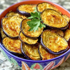 - 1 large eggplant - 2 tablespoons extra virgin olive oil - 1 teaspoon garlic powder - 1 teaspoon smoked paprika - ½ teaspoon sea salt - ½ teaspoon freshly ground black pepper - Optional: ½ teaspoon cayenne pepper for an extra kick Baked eggplant chips are not just tasty; they are also good for you. Each serving is about 100 calories. The macronutrient breakdown is roughly 2 grams of protein, 8 grams of fat, and 7 grams of carbs. These chips are low in calories and high in fiber, making them a smart snack choice. The eggplant is rich in vitamins and minerals. It has antioxidants that help fight free radicals in the body. This makes baked eggplant chips a healthier option compared to regular potato chips. By choosing fresh ingredients, you can make a snack that is both crunchy and nutritious. Follow the Full Recipe to enjoy these crispy treats! 1. Preheat your oven to 425°F (220°C). This hot oven helps the chips become crispy. 2. Rinse the eggplant under cold water. Remove any dirt, then slice it into rounds. Aim for about 1/8 inch thick. Thin slices cook better. 3. Place the eggplant rounds in a colander. Sprinkle them with salt. This draws out moisture and reduces bitterness. Let them sit for about 30 minutes. 1. In a large bowl, mix olive oil, garlic powder, smoked paprika, sea salt, black pepper, and optional cayenne pepper. Stir until well combined. 2. Add the rinsed and dried eggplant slices to the bowl. Toss gently. Make sure each slice gets coated with the tasty mixture. 1. Lay the coated eggplant slices on a baking sheet. Arrange them in a single layer. Avoid overlapping for maximum crispiness. 2. Place the baking sheet in the oven. Bake for 20-25 minutes. Halfway through, flip the slices. This helps them cook evenly. 3. Once they are golden and crispy, take them out. Let the chips cool on the baking sheet for a few minutes. This cooling time helps them firm up and adds a nice crunch. For the full recipe, check out the instructions above. Enjoy your tasty baked eggplant chips! To make your eggplant chips crispy, slice them evenly. Aim for about 1/8 inch thick. This uniform thickness ensures they cook at the same rate. If the slices are too thick, some may end up soggy. Also, lay the slices out in a single layer on the baking sheet. This step prevents them from overlapping, which can trap steam and make them soft. Get creative with flavors! While I love the mix of garlic powder and smoked paprika, you can try other seasonings. Consider using Italian herbs like oregano or basil for a twist. You can also sprinkle on some nutritional yeast for a cheesy flavor. A dash of lemon zest can brighten up the chips too. Experimenting with flavors makes this snack even more fun! Be careful not to over-season your eggplant slices. Too much salt or spice can overpower the natural taste. It’s best to start with a light hand and adjust as needed. Another mistake is not drying the eggplant properly after salting. If you skip this step, excess moisture can lead to chewy chips instead of crispy ones. Make sure to pat them dry well before baking. For the full recipe, check out the detailed instructions above. {{image_4}} You can easily change up the flavors of your baked eggplant chips. One way is by adding parmesan cheese. Just sprinkle some grated parmesan on the eggplant slices before baking. This will give your chips a cheesy, savory taste. You can also try different spices. Instead of garlic powder and smoked paprika, use herbs like oregano or thyme. A dash of cumin or chili powder can add a nice kick too. Mix and match according to your taste. For a healthier option, consider using an air fryer instead of baking. Air fryers use hot air to cook food, making it crispy with less oil. Adjust the cooking time to about 15-20 minutes at 400°F (200°C) for perfect results. If you need gluten-free options, you’re in luck! This recipe is naturally gluten-free. Just ensure that any added seasonings are also gluten-free. This makes it easier for everyone to enjoy the chips. Baked eggplant chips pair well with many dips. Hummus or tzatziki are great choices. They add flavor and creaminess to your snack. You can also serve them with salads. Slice the chips and add them as a crunchy topping on your favorite salad. For a fun side dish, serve these chips alongside grilled meats or roasted veggies. They add a unique twist to your meal. Try these ideas and see which pairings you enjoy the most. For the full recipe, check out the detailed instructions above. To keep your baked eggplant chips fresh, store them in an airtight container. This helps keep moisture out and maintains their crunch. They will stay fresh for about 3 to 5 days. If you want to keep them longer, consider placing them in the fridge. However, they may lose some crispiness over time. When you’re ready to enjoy your leftover chips, the key is to reheat them in the oven. Preheat your oven to 350°F (175°C). Spread the chips on a baking sheet in a single layer. Heat for about 5 to 10 minutes. This will help them regain their crispiness. You can also serve baked eggplant chips with fresh toppings. Try adding some salsa or guacamole for a fun twist. Enjoy your crispy snack! For the full recipe, check out the detailed instructions above. Salting the eggplant is key. When you slice the eggplant, sprinkle it with salt and let it sit. This draws out moisture and bitterness. After about 30 minutes, rinse the slices well. Pat them dry with paper towels. This makes a big difference in taste. Yes, you can use an air fryer! For the best results, set it to 375°F (190°C). Cook for about 15 to 20 minutes. Check them halfway through and shake the basket. This helps them cook evenly. Baked eggplant chips go well with many dips! Try classic hummus for a creamy taste. Tzatziki adds a cool flavor. You can also use guacamole or a spicy salsa. Each dip adds its own fun twist. Absolutely! You can try zucchini, sweet potatoes, or even beets. Just slice them thin, salt them, and follow the same steps. Each veggie brings its own flavor and crunch. Feel free to experiment! Baking eggplant chips is simple and fun. You only need a few key ingredients and clear steps. Remember to salt your eggplant well to draw out moisture. Aim for uniform thickness to achieve that perfect crispiness. Explore different seasonings to find what you love. Store leftovers properly and enjoy them later with your favorite dips. Making these chips can boost your snack game and add a healthy twist. Try them out, and you'll see how tasty they can be!