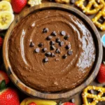 - 1 cup all-purpose flour (heat-treated) - 1/2 cup unsweetened cocoa powder - 1 cup brown sugar, packed - 1/2 cup granulated sugar - 1/2 cup unsalted butter, softened at room temperature - 1 teaspoon pure vanilla extract - 1/4 teaspoon sea salt - 1/2 cup cream cheese, softened - 2 tablespoons milk (adjust more if needed for desired consistency) - 1/2 cup mini chocolate chips Making brownie batter dip is simple and fun. Gather the ingredients first. I use heat-treated flour for safety. This step helps eliminate any risk from raw flour. You need unsweetened cocoa powder for that rich chocolate taste. Brown sugar adds sweetness and depth. Don’t forget granulated sugar to balance the flavors. Softened unsalted butter is key for a creamy texture. It mixes well and makes everything smooth. Pure vanilla extract brings warmth to the dip. A pinch of sea salt enhances the chocolate flavor. Cream cheese adds a rich, velvety quality. Milk is important for the right consistency. You can add more if the dip is too thick. Finally, mini chocolate chips add extra chocolatey bites. Now, you have all you need for this delightful treat. - Step 1: Creaming the Base In a large bowl, mix the softened butter and cream cheese. Add the brown sugar and granulated sugar. Use an electric mixer on medium speed. Beat until smooth and creamy, about 2-3 minutes. - Step 2: Adding Vanilla Pour in the pure vanilla extract. Continue mixing until it blends well into the creamy mixture. The aroma will be delightful! - Step 3: Preparing Dry Ingredients In a separate bowl, whisk together the heat-treated flour, cocoa powder, and sea salt. Make sure there are no lumps. This step is key for a smooth dip. - Step 4: Mixing Everything Together Gradually add the dry ingredients to the creamy mixture. Mix on low speed until just combined. Be careful not to overmix. You want it fluffy, not dense. - Step 5: Achieving the Perfect Consistency Pour in the milk and stir gently. Adjust the milk amount to get your desired creamy texture. The dip should be thick but spreadable. - Step 6: Incorporating Mini Chocolate Chips Fold in the mini chocolate chips with a spatula. Make sure they are evenly spread throughout the dip. This adds a delightful crunch. - Step 7: Serving the Dip Transfer the brownie batter dip to a nice serving bowl. You can top it with extra mini chocolate chips for a fun look. Serve with crunchy pretzels, fresh strawberries, and graham crackers for dipping. Enjoy your treat! - Recommended Mixing Techniques: Start by mixing the butter and cream cheese together. Use an electric mixer on medium speed. This creates a smooth and creamy base. Beat it for about 2-3 minutes. Then, add the sugars and vanilla. Mix until it’s well combined. - Adjusting Consistency with Milk: After mixing in the dry ingredients, pour in the milk. This helps to reach your desired dip consistency. If it seems too thick, add a bit more milk. Stir gently until you achieve a creamy texture. - Avoiding Overmixing: When you add the dry mix, use low speed. Mix just until combined. Overmixing can make the dip tough. You want a light and fluffy texture. Fold in the chocolate chips gently to keep their shape. - Creative Dippable Pairings: Serve your brownie batter dip with fun dippers. Use crunchy pretzels for a sweet-salty mix. Fresh strawberries and sliced bananas add a fruity touch. Classic graham crackers are also a great choice. - Garnishing Ideas: For a pretty finish, scatter some extra mini chocolate chips on top. You can also add a drizzle of melted chocolate. This makes the dip look fancy and inviting. {{image_4}} You can boost the flavor of your brownie batter dip in fun ways. - Adding Peanut Butter or Nutella: Swirling in peanut butter or Nutella makes it rich. Just mix in 1/4 cup of either. It adds a creamy texture and a nutty sweetness. - Infusing Other Flavor Extracts: A few drops of almond or mint extract can change the taste. Try 1/2 teaspoon for a new twist. These flavors blend well with chocolate and give a fresh kick. You can enjoy brownie batter dip even if you have special diets. - Gluten-Free Options: Use gluten-free flour instead of all-purpose flour. This keeps the dip tasty and safe for everyone. Many brands work well as substitutes. - Vegan Version of Brownie Batter Dip: To make it vegan, swap the butter and cream cheese for plant-based options. Use coconut oil and vegan cream cheese. This way, you can enjoy the dip without dairy. These variations let you customize your dip. You can make it richer or fit different diets. Enjoy exploring these options! To keep your brownie batter dip fresh, store it in the fridge. Use an airtight container for the best results. This keeps the dip creamy and tasty. It can stay fresh for up to five days. Before serving, give it a quick stir. If it thickens in the fridge, add a splash of milk to make it smooth again. For longer storage, you can freeze brownie batter dip. Use a freezer-safe container, leaving some space at the top. This dip can last for about three months in the freezer. When ready to eat, let it thaw overnight in the fridge. After thawing, stir it well. You may need to add a bit of milk to regain that perfect creamy texture. Enjoy your sweet treat whenever you like! Yes, you can make Brownie Batter Dip ahead of time. This dip tastes even better after chilling. Just cover it well and place it in the fridge. Make it a day in advance for the best flavor. Brownie Batter Dip lasts about 3 to 5 days in the fridge. Store it in an airtight container to keep it fresh. If you notice any change in smell or texture, it's best to toss it. You can serve it with many fun dippables. Some tasty options include: - Crunchy pretzels - Fresh strawberries - Sliced bananas - Graham crackers Feel free to mix and match for added fun! Using heat-treated flour makes it safe to eat. Cooking the flour kills any harmful bacteria. Always ensure your ingredients are safe before enjoying this delicious dip. To make your dip thicker, add more cream cheese. If you want it creamier, stir in more milk. Adjust slowly until you reach your desired texture. This blog post covered how to make a tasty Brownie Batter Dip. We explored key ingredients and step-by-step instructions, offering tips for the best results. You can make it your own with fun variations or dietary tweaks. Now, enjoy this dip with friends or family. Remember, the right dips make snacks fun. Use your creativity for great presentations. Keep experimenting, and you'll find what works best for you. Happy dipping!