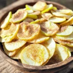 - 2 large apples (Granny Smith or Honeycrisp) - 1 teaspoon ground cinnamon - 1 tablespoon brown sugar (optional) - A pinch of salt - Cooking spray or coconut oil - Air fryer - Mixing bowl - Cutting board and knife - Wire rack For this recipe, I use two large apples. Granny Smith or Honeycrisp apples work best. They are crisp and sweet, perfect for chips. You need one teaspoon of ground cinnamon for flavor. If you like your chips sweeter, add one tablespoon of brown sugar. A pinch of salt balances the sweetness. You also need cooking spray or a bit of coconut oil to help the cinnamon mix stick to the apples. Next, gather your equipment. An air fryer is a must for this recipe. A mixing bowl helps you blend the cinnamon and sugar. A cutting board and knife are needed to slice the apples. Lastly, a wire rack lets your chips cool and get even crisper. With these ingredients and tools ready, you will make tasty cinnamon apple chips in no time! 1. First, wash two large apples. I like using Granny Smith or Honeycrisp for their crispness. 2. Next, core each apple. This means removing the center part with seeds. 3. Slice the apples into thin rounds. Aim for about 1/8 inch thick. Keeping the skin on adds flavor and nutrients. 1. In a small bowl, combine one teaspoon of ground cinnamon, one tablespoon of brown sugar, and a pinch of salt. 2. Mix these ingredients well. This creates a tasty cinnamon sugar mixture to sprinkle on the apples. 1. Preheat your air fryer to 300°F (150°C) for about 3-5 minutes. 2. Arrange the apple slices in the air fryer basket. Make sure not to overcrowd them. 3. Sprinkle the cinnamon sugar mixture over the apple slices. Toss them gently to coat each slice. 4. Cook the apple slices for 15-20 minutes. Flip them halfway through to ensure even cooking. 5. Keep an eye on them. Cooking times can change based on your air fryer. 6. Once they are done, take them out and let them cool on a wire rack. They will get crispier as they cool. 7. If you have any leftover apple chips, store them in an airtight container to keep them crunchy. - Avoid overcrowding the basket. Give each slice space to breathe. This helps them cook evenly. - Monitor cooking time closely. Check the apple chips often. Cooking time can change based on your air fryer. - Consider adding nutmeg or vanilla extract. These spices can add a warm, rich taste. - Experiment with different apple varieties. Try Fuji, Gala, or even Pink Lady. Each type gives a unique flavor and texture. {{image_4}} If you want to skip sugar, you can still enjoy these apple chips. Just substitute brown sugar with a sugar alternative like stevia or erythritol. Both options add sweetness without the calories. This way, you keep the taste but cut down on sugar. Feel free to experiment with spices! You can add ginger or cloves for a new flavor twist. These spices give your chips a warm, cozy touch. Another idea is to mix cinnamon with cocoa powder. This combination creates a chocolatey apple chip that tastes amazing. It adds a rich layer of flavor that surprises your taste buds. Enjoy trying these variations to find your favorite! To keep your apple chips fresh, use an airtight container. This will help keep moisture out. Store them in a cool, dry place, like a pantry or cupboard. Avoid areas with heat or humidity. Apple chips last about one week at room temperature. If you want to keep them longer, consider freezing them. Place apple chips in a freezer-safe bag. They can last for several months in the freezer. When you want to enjoy them again, just thaw and crisp them up in the air fryer. Yes, you can use many fruits! Try pears, bananas, or even sweet potatoes. Each fruit gives a unique taste and texture. Just slice them thinly, like the apples. Use the same method for air frying. Each fruit will need its own cooking time, so keep an eye on them. Look for a nice golden color and a crisp feel. They should feel dry and break easily when you touch them. If they are still soft, give them more time in the air fryer. Remember to flip them halfway through for even cooking. You sure can! To keep them crispy, use your air fryer again. Heat them at a low temperature for about 5 minutes. This helps remove any moisture and brings back their crunch. Avoid using the microwave, as it makes them soggy. For the full instructions, check out the [Crispy Air Fryer Cinnamon Apple Chips](#) recipe. You learned how to make tasty air fryer apple chips. We covered the ingredients, equipment, and easy steps. I shared tips for the best crispiness and flavor. You can even try sugar-free options or new spices. Store your chips right for lasting crunch. These apple chips are a fun and healthy snack. I hope you enjoy making them as much as I do! Now go ahead and create your own delicious batch.