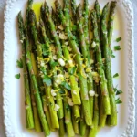 - 1 pound fresh asparagus, trimmed - 3 cloves garlic, finely minced - Zest of 1 large lemon - Juice of 1 large lemon - Fresh parsley, finely chopped for garnish - 3 tablespoons extra virgin olive oil - 1 teaspoon fine sea salt - 1/2 teaspoon freshly cracked black pepper - 1/4 teaspoon red pepper flakes (optional, adjust to taste) - Grated Parmesan cheese for garnish (freshly grated recommended) You need fresh asparagus for this dish. Look for bright green spears. They should be firm and not limp. The garlic adds a nice punch. Lemon gives a bright flavor that contrasts well with the asparagus. Extra virgin olive oil helps the asparagus cook and adds richness. Salt and pepper enhance the overall taste. Red pepper flakes can add a little heat if you like spice. For garnishes, grated Parmesan cheese makes everything better. It adds a salty, creamy touch. Fresh parsley gives a pop of color and freshness. You can skip these if you want a lighter dish. First, set your oven to 425°F (220°C). A hot oven helps the asparagus roast well. Next, take one pound of fresh asparagus and trim off the tough ends. Place the asparagus in a large bowl. Pour in three tablespoons of extra virgin olive oil. Make sure every piece gets a nice coat of oil. Add three cloves of finely minced garlic. This will give lovely flavor. Then, add the zest of one large lemon and the juice of that lemon. Toss in one teaspoon of fine sea salt and half a teaspoon of freshly cracked black pepper. If you like some heat, add a quarter teaspoon of red pepper flakes. Toss everything together until the asparagus is covered in the mix. Now, spread the asparagus on a baking sheet. Arrange it in a single layer so it roasts evenly. Avoid crowding the pan, as this can cause steaming instead of roasting. Place the baking sheet in the oven and roast for 12 to 15 minutes. The asparagus should be tender and have a golden edge. After roasting, carefully take the baking sheet out of the oven. Let the asparagus cool for about a minute. Then, transfer it to a serving platter. For a nice finish, sprinkle some grated Parmesan cheese and freshly chopped parsley on top. This will add flavor and make it look great. For a stunning presentation, arrange the asparagus in a fan shape. Drizzle any leftover lemon juice over the top before serving. Enjoy your delicious dish! When picking asparagus, look for bright green spears. They should feel firm and not bend easily. The tips should be tightly closed and fresh. If the spears are limp or have a dull color, skip them. Fresh asparagus tastes best and adds flavor to your dish. Every oven heats a bit differently. If you have a convection oven, reduce the cook time by about 2-3 minutes. Check the asparagus after 10 minutes for doneness. The goal is tender spears with a slight crispness. If you have a traditional oven, stick to the full 12-15 minutes. For extra flavor, try adding lemon zest. It gives a bright taste that pairs well with garlic. You can also sprinkle more herbs, like thyme or rosemary, for a different twist. Adding red pepper flakes gives a nice kick. Remember, presentation matters too! Arrange the asparagus nicely and garnish with Parmesan and parsley for a stunning look. {{image_4}} You can change the cheese on top for more flavor. Try feta for a tangy kick. Goat cheese adds creaminess, while Asiago brings a nutty taste. Just sprinkle the cheese on right after roasting. The heat will melt it slightly. This adds richness and depth to your dish. Mixing in other veggies makes a great side dish. Carrots and bell peppers roast well with asparagus. Cut them into similar sizes for even cooking. You can also add broccoli for a colorful blend. Toss them all together with the lemon and garlic for full flavor. Herbs can change the taste of your asparagus. Try thyme or rosemary for an earthy note. You can also use dill for a fresh twist. If you want spice, add cumin or smoked paprika. Just sprinkle these spices before roasting to enhance the overall flavor. Store leftover asparagus in an airtight container. Make sure to let it cool first. Keep it in the fridge. It stays fresh for about three days. If you want to keep it longer, consider freezing it. This way, you can enjoy it later. You can reheat the asparagus or serve it cold. To reheat, use the oven or microwave. If using the oven, preheat it to 350°F (175°C). Place the asparagus on a baking sheet. Heat for about 5 to 10 minutes until warm. If you prefer it cold, simply take it from the fridge and enjoy. Freezing asparagus is easy. First, blanch it in boiling water for two minutes. Then, cool it in ice water to stop the cooking. Drain and pat dry. Place the asparagus in freezer bags, removing as much air as possible. Label the bags with the date. Frozen asparagus lasts for about three months. Use it in soups or stir-fries for a quick meal. Yes, you can use frozen asparagus. However, fresh is better. Frozen asparagus may become mushy when roasted. If you choose frozen, thaw it first. Pat it dry to remove excess moisture. This helps keep it firm and tasty. Lemon Garlic Roasted Asparagus pairs well with many dishes. Here are some ideas: - Grilled chicken or fish - Quinoa or rice - Pasta with olive oil - A fresh salad - Steak or pork chops These options complement the bright flavors of the asparagus. Asparagus is done when it turns tender and slightly golden. Look for a slight browning on the edges as well. It should still have a little snap when you bite into it. You can test one spear if you're unsure. Yes, you can easily make this recipe vegan. Simply skip the Parmesan cheese. You can replace it with a vegan alternative if you want. The dish is still flavorful and will taste great without cheese. Enjoy the fresh lemon and garlic flavors! Lemon garlic roasted asparagus is simple and delicious. We explored fresh ingredients, essential pantry items, and optional garnishes to enhance flavor. I provided step-by-step instructions for perfect roasting and shared tips for choosing and cooking asparagus. Different variations allow you to customize this dish, and I discussed storage tips for leftovers. This dish is versatile, healthy, and easy to make. Enjoy experimenting with it!