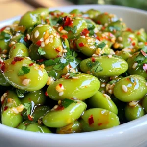 To make spicy garlic edamame, gather these simple ingredients: - 2 cups shelled edamame (fresh or frozen) - 4 cloves of garlic, finely minced - 2 tablespoons extra virgin olive oil - 1 teaspoon red pepper flakes - 1 tablespoon soy sauce (or tamari for gluten-free) - 1 teaspoon toasted sesame oil - 1 tablespoon freshly squeezed lemon juice - Sea salt, to taste - Fresh cilantro or sliced green onions for garnish (optional) These ingredients come together to create a flavorful snack. The edamame adds protein, while the garlic gives a savory kick. Red pepper flakes bring heat, and lemon juice adds brightness. Each element plays a role in making this dish tasty and fun. You can adjust the spice level by changing the amount of red pepper flakes. If you want more flavor, try adding more garlic or lemon juice. {{ingredient_image_2}} To cook frozen edamame, start by boiling water in a pot. Add the edamame to the pot and cook for about 5-6 minutes, or until tender. After cooking, drain the edamame well and set it aside. This step gives the beans a great texture for our spicy dish. Next, heat 2 tablespoons of extra virgin olive oil in a large skillet over medium heat. Wait for about 1-2 minutes until the oil shimmers. Then, add 4 cloves of finely minced garlic to the skillet. Sauté the garlic for 1-2 minutes, stirring often. You want it fragrant and lightly golden but not browned. If it browns, it can taste bitter. Now, it’s time to add some heat! Sprinkle in 1 teaspoon of red pepper flakes and stir for about 30 seconds. This will release their spicy flavor into the oil. Carefully add the cooked edamame to the skillet next. Toss the edamame with the garlic and oil mixture using a spatula. Make sure every bean gets coated well. Then, pour in 1 tablespoon of soy sauce and 1 teaspoon of toasted sesame oil, stirring to combine. This will infuse the beans with tasty flavors. For the last touches, squeeze in 1 tablespoon of fresh lemon juice. Toss everything one more time to mix well. Taste the dish and add sea salt as needed. Adjust the seasoning to your liking. Remove the skillet from heat and transfer the spicy edamame to a serving bowl. You can serve it warm as a side dish or appetizer. For a nice presentation, garnish with fresh cilantro or sliced green onions. If you like, add lime wedges for a zesty kick before serving. Enjoy your flavorful and easy snack! When picking edamame, you can choose fresh or frozen. Fresh edamame may have a vibrant green color and a firm texture. Frozen edamame is easy to find and works well. Check the package for signs of freezer burn, which shows poor quality. If you see any brown spots or ice crystals, skip that bag. You can change the heat in your dish easily. Start with one teaspoon of red pepper flakes. If you want more spice, add more. You can also try other spices, like cayenne pepper or chili powder. Just remember to taste as you go! There are many ways to make your dish more exciting. Use different sauces, like teriyaki or ponzu, to change the taste. For crunch, add toasted nuts or seeds, such as sesame seeds or slivered almonds. These will give your edamame a nice texture. Pro Tips Adjust the Spice Level: Feel free to modify the amount of red pepper flakes based on your personal heat preference. Start with less and add more if you like it spicier! Use Fresh Ingredients: Using fresh garlic instead of pre-minced can elevate the flavor of the dish significantly. Fresh herbs also add a delightful touch. Perfectly Cooked Edamame: If using frozen edamame, be sure not to overcook them. They should be tender but still have a slight bite for the best texture. Garnish for Flavor: Adding fresh cilantro or sliced green onions not only enhances the presentation but also adds a burst of fresh flavor to each bite. {{image_4}} You can swap out soy sauce for different options. Use liquid aminos for a light taste. If you want a gluten-free choice, tamari works well. You can also try coconut aminos for a sweeter flavor. For seasoning, garlic is great, but you can explore other options. Try ginger for a fresh twist. Or use a splash of rice vinegar for tang. These changes make the dish unique. When cooking edamame, you can choose between steaming and boiling. Steaming keeps more nutrients. It also gives a firmer texture. Boiling is faster but may lose some flavor. Air frying can add a crunchy texture. This method gives the edamame a nice crisp. Simply toss them in the air fryer with a bit of oil and cook until golden. Spicy garlic edamame pairs well with many dishes. Serve it as a side with rice or noodles. It also complements sushi or grilled meats nicely. You can transform it into a salad or bowl. Add fresh greens, diced veggies, and a dressing. This makes a colorful and healthy meal. Mix and match to suit your taste! After making Spicy Garlic Edamame, store leftovers in an airtight container. Keep it in the fridge. It stays good for about 3 days. When you want to eat it again, just check for any odd smells or textures. If it looks fine, you’re good to go! To save edamame for later, freezing is the best choice. First, let the cooked edamame cool to room temperature. Then, place it in a freezer-safe bag. Squeeze out as much air as you can. This helps prevent freezer burn. You can freeze the edamame for up to 3 months. When you’re ready to use it, just thaw it in the fridge overnight. When it’s time to enjoy your leftovers, reheat them in a skillet over medium heat. Add a splash of water to help steam them. Stir often until they are warmed through. You can also use the microwave. Place them in a bowl, cover with a damp paper towel, and heat in 30-second intervals, stirring in between. This keeps them moist and tasty! Edamame is packed with nutrients. It contains protein, fiber, and healthy fats. - Nutritional content overview: A serving of edamame has about 17 grams of protein. It also has fiber, iron, and calcium. - Benefits of protein and fiber: The protein helps build muscles. The fiber aids digestion and keeps you full longer. Yes, you can prepare this dish in advance. - Preparing in advance and storing: Cook the edamame and toss it with the garlic mix. Store it in the fridge for up to three days. Reheat it before serving for the best taste. If you need to avoid soy sauce, there are great alternatives. - Gluten-free alternatives: Use tamari for a gluten-free option. Coconut aminos is another tasty choice. - Other flavorful substitutes: You can try liquid aminos or even a homemade mix of broth with a splash of vinegar for depth. This blog post covered how to make a tasty edamame dish. You learned about the key ingredients, step-by-step instructions, and tips to enhance flavor. We also explored variations, storage tips, and answered common questions. Making this dish can fill your meal with healthy benefits. I hope you feel inspired to try it at home! Enjoy your cooking adventure and make it your own.