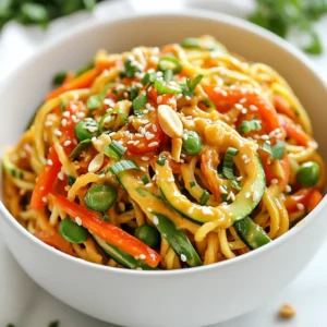 - 2 medium zucchinis - 1 red bell pepper - 1 cup snap peas - 1 medium carrot - 1/4 cup green onions - 1 tablespoon sesame oil - 1 tablespoon extra virgin olive oil - 1/4 cup creamy peanut butter - 2 tablespoons soy sauce or tamari - 2 tablespoons pure maple syrup - 1 tablespoon sriracha - 1 clove garlic - 1 teaspoon fresh ginger - Salt and freshly ground black pepper - Garnishes: Chopped peanuts, toasted sesame seeds In this Spicy Peanut Zoodle Bowl, we use fresh veggies. The zucchinis make zoodles. They give a fun twist to the dish. The red bell pepper adds sweetness. Snap peas bring a nice crunch. The carrot also adds color and texture. We combine oils and sauces for flavor. Sesame oil and olive oil blend well. Creamy peanut butter makes the sauce rich. Soy sauce adds saltiness. Maple syrup gives a hint of sweetness. Sriracha adds that spicy kick. You can adjust the amount to suit your taste. The spices round out the dish. Fresh garlic and ginger add warmth. Don't forget to season with salt and black pepper. Finally, garnishes like chopped peanuts and toasted sesame seeds add crunch. This dish is a mix of flavors and textures. It makes for a bold and flavorful meal that’s sure to impress. {{ingredient_image_2}} Using a spiralizer or a vegetable peeler, create zoodles from the zucchinis. I like to choose firm zucchinis. They spiralize better and have great flavor. Place the zoodles in a bowl and set them aside. This keeps them fresh and ready to mix later. In a large skillet, heat sesame oil and olive oil over medium heat. When the oils shimmer, add the sliced red bell pepper, snap peas, and julienned carrot. Sauté the vegetables for about 3-4 minutes. Stir occasionally. You want them tender but still crisp. In a small bowl, whisk together peanut butter, soy sauce, maple syrup, sriracha, minced garlic, and grated ginger. Mix until smooth and well combined. If your sauce looks too thick, add a tablespoon of water. This helps you reach the right consistency. Add the prepared zoodles to the skillet with the sautéed vegetables. Pour the peanut sauce over them. Gently toss everything together using tongs or a spatula. Make sure the zoodles and vegetables are coated in the sauce. Keep cooking for another 2-3 minutes to warm the zoodles. Remove from heat and taste your dish. Adjust the seasoning with salt, freshly ground pepper, or more sriracha if you want more heat. This is your chance to make it just right. Serve the zoodle bowl immediately while it’s warm. For a beautiful presentation, use wide, shallow bowls. This shows off the vibrant colors of your dish. Drizzle a little extra sriracha on top for a pop of color. Garnish with chopped green onions, crunchy peanuts, and toasted sesame seeds for extra flavor and crunch. To make the peanut sauce just right, start with the base. Use creamy peanut butter for smoothness. Adjust the spice by adding more sriracha for heat. If it's too thick, add water. This keeps the sauce runny but still tasty. A little maple syrup balances the flavors well, making every bite great. When making zoodles, pick firm, fresh zucchinis. Look for medium-sized ones for best results. Use a spiralizer for perfect noodles. If you don’t have one, a vegetable peeler works too. Just slice the zucchini into thin strips. This gives you a nice texture. For easy meal prep, spiralize the zucchinis a day ahead. Store them in an airtight bag to keep them fresh. You can also make the peanut sauce in advance. Just keep it in the fridge in a jar. This way, you save time when you’re ready to cook. Pro Tips Adjust the Spice Level: Feel free to customize the amount of sriracha in the peanut sauce to match your preferred spice tolerance. Choose Fresh Vegetables: Always opt for fresh, vibrant vegetables to enhance both the flavor and visual appeal of your zoodle bowl. Make it a Meal Prep: Prepare extra servings and store them in the fridge for quick, healthy lunches throughout the week. Experiment with Toppings: Try adding sliced avocado, cilantro, or lime wedges for an extra burst of flavor and freshness. {{image_4}} You can add protein to your Spicy Peanut Zoodle Bowl for extra flavor. Try adding cooked chicken, tofu, or shrimp. Each option brings its unique taste and texture. When adding chicken, use cooked, shredded pieces for the best results. For tofu, choose firm tofu, cut it into cubes, and sauté until golden. Shrimp cooks quickly and adds a nice pop of flavor. Simply toss in the protein during the last few minutes of cooking. Feel free to customize the vegetables in your bowl. If you want a change, substitute the red bell pepper with yellow or green bell peppers. Broccoli florets or sliced asparagus also work well. You can even add mushrooms for an earthy touch. Use whatever vegetables you enjoy most. This dish allows you to be creative and make it your own. This recipe is easy to adjust for dietary needs. For a gluten-free option, use tamari instead of soy sauce. If you want a vegan dish, choose tofu as your protein source and make sure the peanut butter is free of additives. You can leave out the honey or maple syrup and use agave nectar instead. These swaps keep the dish delicious while catering to a variety of diets. To keep your Spicy Peanut Zoodle Bowl fresh, store leftovers in an airtight container. Make sure to let the dish cool first. It will stay good in the fridge for about 3 days. When you are ready to eat, check for any signs of spoilage. If it looks or smells off, it's best to toss it. For reheating, you have a few good options. The microwave works well. Just place the bowl in for 1-2 minutes. Stir halfway through to heat evenly. If you prefer, you can also use a skillet. Heat on low and stir until warm. This way, you keep the zoodles from getting too mushy. You can freeze this dish for later. To do this, place your zoodle bowl in a freezer-safe container. Make sure to leave some space at the top, as the dish may expand. It can stay frozen for about 2 months. When you want to eat it, thaw it overnight in the fridge. Reheat it using the methods mentioned above. Yes, you can. If you want to swap zoodles, try rice noodles, soba noodles, or whole wheat spaghetti. Each option offers a different texture and taste. For a gluten-free dish, use rice noodles or gluten-free pasta. The spice level can change based on the amount of sriracha you use. The recipe suggests one tablespoon, which gives a nice kick. If you want it hotter, add more sriracha. If you prefer it milder, use less. Taste the sauce before mixing it with the zoodles. This dish pairs well with a side salad or spring rolls. You can also serve it with grilled chicken or tofu for extra protein. A light soup, like miso, adds a nice touch too. Yes, this recipe is quite healthy. It uses fresh veggies that are low in calories but high in fiber. Zucchini zoodles are a great low-carb substitute. Peanut butter adds protein and healthy fats. The dish is also rich in vitamins and minerals. This blog covers how to create a tasty Spicy Peanut Zoodle Bowl using fresh veggies and flavorful sauces. You learned to prepare zoodles, sauté vegetables, and mix a rich peanut sauce. Remember, you can adjust spice levels and swap ingredients to fit your taste. Enjoy trying out the meal prep tips and storage info to keep it fresh. With these ideas, you can make a quick, fun, and healthy dish perfect for any day. Get creative and enjoy your cooking journey!