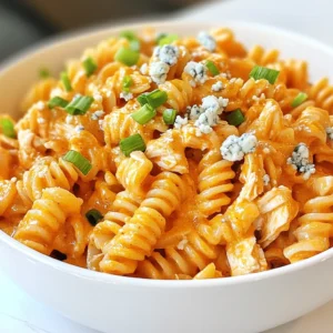 When making creamy buffalo chicken pasta, gather these key ingredients: - Pasta Types: 2 cups rotini or penne pasta - Chicken: 2 cups shredded cooked chicken breast - Aromatics: 2 tablespoons olive oil, 1 small onion (finely chopped), 3 cloves garlic (minced) - Buffalo Sauce and Dairy: 1 cup buffalo sauce, 1 cup heavy cream, 1/2 cup sour cream, 1/2 cup grated Parmesan cheese - Seasonings: Salt and black pepper to taste - Optional Toppings: Chopped green onions, crumbled blue cheese These ingredients create a rich, flavorful dish. The pasta gives a perfect base, while the chicken adds protein. Aromatics like onion and garlic bring depth to the sauce. Buffalo sauce adds heat and tang. Heavy cream and sour cream create a smooth texture, making every bite creamy. Finally, Parmesan cheese gives a salty kick. Optional toppings like green onions and blue cheese add a fresh finish. Collect these items, and you're ready to dive into a delicious cooking adventure! {{ingredient_image_2}} 1. Start by boiling a large pot of salted water. 2. Once the water boils, add 2 cups of rotini or penne pasta. 3. Cook for 8-10 minutes or until al dente. 4. Next, drain the pasta in a colander and set it aside. 1. In a large skillet, heat 2 tablespoons of olive oil over medium heat. 2. Add 1 small chopped onion and sauté for 3-4 minutes. 3. Stir until the onion is soft and clear. 4. Add 3 minced garlic cloves and sauté for another minute. 1. Mix in 2 cups of shredded cooked chicken with the aromatics. 2. Pour in 1 cup of buffalo sauce and stir well. 3. Allow the mixture to simmer for 3-5 minutes to heat through. 1. Lower the heat and slowly pour in 1 cup of heavy cream. 2. Add 1/2 cup of sour cream and stir until smooth. 3. Incorporate 1/2 cup of grated Parmesan cheese and mix well. 4. Taste and adjust with salt and black pepper as needed. 1. Carefully fold the cooked pasta into the creamy buffalo chicken sauce. 2. Use a spatula to gently toss until all pasta is coated evenly. 1. Remove the skillet from heat and serve hot. 2. Garnish each plate with chopped green onions. 3. Sprinkle crumbled blue cheese on top if you like. - Adjusting Spice Levels to Taste Start with one cup of buffalo sauce. This gives a nice kick. If you like it hotter, add more sauce, a little at a time. Taste as you go. You want to enjoy the heat without overwhelming your palate. - How to Achieve the Right Creaminess For a creamy sauce, use both heavy cream and sour cream. The heavy cream gives richness. The sour cream adds tanginess. Stir these in slowly over low heat. This helps create a smooth texture. - Cooking Pasta Al Dente Always cook your pasta al dente. This means it should be firm to the bite. Follow the package instructions, usually 8 to 10 minutes. Taste the pasta before draining. It should not be mushy. - Preventing Pasta from Sticking To keep your pasta from sticking, stir it well while cooking. Use enough water, so the pasta has room to move. After draining, toss it with a bit of olive oil. This will keep it loose. - Using Pre-Cooked Chicken If you're short on time, use pre-cooked chicken. This cuts down on cooking time. You can find it in stores or make it in advance. Shred it before adding to your sauce. - Preparing Ingredients in Advance Chop your onion and garlic ahead of time. You can also measure out your sauces and creams. This way, when it's time to cook, you can focus on mixing everything. It makes the process smooth and quick. Pro Tips Adjust the Heat: Feel free to add more or less buffalo sauce based on your spice tolerance. Start with a smaller amount and gradually increase to find your perfect balance. Add Veggies: Incorporate your favorite vegetables like bell peppers or spinach during the sautéing process for added nutrition and color. Make it Ahead: This dish can be made ahead and stored in the fridge for up to three days. Reheat gently on the stovetop with a splash of cream to revive the sauce. Garnish Creatively: Experiment with different toppings like cilantro, diced tomatoes, or jalapeños to customize each serving and enhance flavor. {{image_4}} You can make this dish healthier with simple changes. - Using Whole Wheat or Gluten-Free Pasta: Whole wheat pasta adds fiber. It gives a nutty taste. Gluten-free pasta is a great choice too. It helps those with gluten issues. Both options work well in this recipe. - Low-Fat Dairy Alternatives: Swap heavy cream with low-fat milk or cashew cream. Sour cream can change to Greek yogurt. These swaps cut calories without losing flavor. Add your twist to this dish for even more fun. - Adding Vegetables: Bell peppers and spinach are great choices. They boost nutrition and color. You can sauté them with onions. This mix adds a fresh touch to the pasta. - Alternative Sauces: Mix BBQ sauce with buffalo sauce for a sweet kick. This combo gives a new flavor layer. You can adjust the spice according to your taste. Want to serve more or fewer people? It's easy! - Increasing Servings: To double the recipe, simply double all the ingredients. This ensures everyone gets enough creamy goodness. - Reducing Servings: If you want less, just halve the ingredients. This makes it perfect for a quick lunch or a small dinner. To keep your creamy buffalo chicken pasta fresh, store it in the fridge. Place the pasta in an airtight container. This helps prevent drying out. Make sure to cool the pasta first. It should be at room temperature before sealing. Store it for up to three days. You can reheat your pasta in two easy ways. Use a microwave or stovetop. If using a microwave, place the pasta in a bowl. Add a splash of water or cream to keep it moist. Heat in short bursts, stirring in between. For the stovetop, use a skillet. Add a little cream to the pan. Heat gently, stirring until warm. This keeps the sauce creamy and delicious. You can freeze your creamy buffalo chicken pasta. Freeze it before or after cooking. If freezing before cooking, place the uncooked pasta and sauce in a freezer bag. If freezing after, let it cool first. Store in a freezer-safe container. It stays good for up to three months. To defrost, move it to the fridge overnight. Reheat it as mentioned above. Enjoy your tasty pasta later! Yes, you can use rotisserie chicken. It saves time and adds great flavor. Simply shred the chicken and add it to the dish as you would with cooked chicken breast. This makes the recipe even easier, especially for busy weeknights. To boost the heat, add more buffalo sauce to the dish. You can also mix in a pinch of cayenne pepper or red pepper flakes. For extra kick, try diced jalapeños or hot sauce. Adjust the spice level to suit your taste for the perfect spicy creamy buffalo chicken pasta. You can use milk, but the dish will not be as creamy. If you want a rich taste, consider using half-and-half or a mix of milk and cream. This keeps the sauce smooth while still reducing calories a bit. This dish pairs well with a crisp salad or garlic bread. Roasted veggies like broccoli or carrots also make a great side. You can even serve it with a light soup for a complete meal. Creamy buffalo chicken pasta lasts about three to four days in the fridge. Store it in an airtight container to keep it fresh. Reheat it gently to enjoy leftovers without losing flavor. This blog post guides you through making creamy buffalo chicken pasta. You learned about the key ingredients, like rotini pasta and shredded chicken. The step-by-step instructions show you how to cook pasta, sauté aromatics, and mix in the sauce. Tips help you perfect your dish, while variations allow for creativity. You can store leftovers safely and reheat them easily. Making this dish will impress your family and friends. Enjoy every bite, and don’t hesitate to try new flavors!