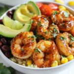 - 1 lb shrimp, peeled and deveined - 2 cups quinoa (or rice) - 2 tablespoons chipotle sauce - 1 cup corn (fresh, canned, or frozen) - 1 cup black beans, rinsed and drained - 1 ripe avocado, diced - 1 cup cherry tomatoes, halved The shrimp form the base of this dish. They add protein and flavor. Choose fresh shrimp if possible. Quinoa or rice works well as the base. Both provide good texture and nutrients. Chipotle sauce brings the heat and smokiness. Fresh veggies add color and crunch. - 2 tablespoons olive oil - Juice of 2 limes - 1 teaspoon garlic powder - 1 teaspoon ground cumin - Salt and pepper to taste The olive oil helps the shrimp cook evenly. Lime juice adds brightness. Garlic powder and cumin enhance the shrimp's flavor. Salt and pepper balance the taste. These seasonings make each bite burst with flavor. - Fresh cilantro, chopped - Lime wedges Cilantro adds a fresh touch to the dish. Lime wedges give a zesty kick when squeezed on top. These garnishes not only look good but also uplift the taste. This recipe uses simple yet fresh ingredients. Each one plays a role in making the dish tasty and satisfying. Enjoy preparing your Chipotle Lime Shrimp Bowls! {{ingredient_image_2}} Start by mixing shrimp with the marinade. In a large bowl, combine peeled and deveined shrimp with olive oil, chipotle sauce, lime juice, garlic powder, cumin, salt, and pepper. Gently toss the shrimp until they are coated in the marinade. Let the shrimp rest for 15-20 minutes at room temperature. This resting time helps the flavors seep into the shrimp. Next, bring 4 cups of water to a rolling boil in a medium saucepan. Stir in 2 cups of quinoa or rice, adding a pinch of salt. Lower the heat and cover the pot. Let it simmer for about 15 minutes for quinoa or 20 minutes for rice. Check to see if the grains are tender and the water is absorbed. Heat a non-stick skillet over medium-high heat. Add the marinated shrimp in a single layer. Cook the shrimp for 2-3 minutes on each side. They should turn pink and opaque. Be careful not to overcook them; this will keep them tender. Once done, remove the shrimp from heat and set them aside. While the shrimp cooks, warm 1 cup of corn and 1 cup of black beans in a small saucepan over low heat. Stir occasionally for about 5 minutes until they are heated through. This ensures even warming of the ingredients. To create your bowls, start with a base layer of cooked quinoa or rice. Next, add in the warmed black beans and corn. Place the cooked chipotle lime shrimp on top. Finish by adding diced avocado and halved cherry tomatoes for a fresh touch. To finish, sprinkle freshly chopped cilantro over the bowls for added flavor. Serve with lime wedges on the side, inviting everyone to squeeze fresh lime juice over their bowls. This gives an extra zest to each bite. - How long to marinate for best flavor: Marinate the shrimp for 15 to 20 minutes. This time lets the shrimp soak up all the great flavors. If you marinate too long, the shrimp can get mushy. - Alternative marinade ideas: Try mixing lime juice with honey and garlic for a sweet twist. You can also use a mix of soy sauce and ginger for a different flavor profile. - Visual indicators of doneness: Cook shrimp until they turn bright pink and opaque. This shows they are done. Avoid cooking them too long, or they will become tough. - Preventing shrinkage: Cook shrimp on medium-high heat. This helps them cook quickly without losing too much moisture. - Ideal side dishes: Serve your shrimp bowls with a side of fresh salad or roasted veggies. These add color and nutrients to your meal. - Making it a complete meal: Include quinoa or rice as a base for your shrimp. Add black beans and corn to round out the meal. You can top it with avocado and tomatoes for extra flavor and texture. Pro Tips Marinate for Maximum Flavor: Allow the shrimp to marinate for at least 20 minutes to enhance the flavor absorption. For even better results, marinate for up to an hour in the refrigerator. Perfectly Cooked Shrimp: Keep a close eye on the shrimp while cooking. They should turn pink and opaque in about 2-3 minutes per side. Overcooking can make them tough and rubbery. Ingredient Freshness: Use fresh ingredients whenever possible, especially for the avocado and tomatoes, to ensure the best flavor and texture in your bowls. Customize Your Bowl: Feel free to add your favorite toppings such as cheese, jalapeños, or a dollop of sour cream for added richness and flavor diversity. {{image_4}} If you want to swap out shrimp, try using chicken or tofu. Chicken works well with the same spices. Tofu will soak up the flavor nicely. Both options still give you a tasty bowl. When it comes to grains, quinoa and rice are great choices. You can also use farro or couscous. Each grain adds a unique texture and taste. Just make sure to adjust cooking times based on the grain you choose. To make the dish even more exciting, add spices like smoked paprika or cayenne. These spices bring a warm kick. You can also try adding chili powder for extra depth. Each spice can change the whole flavor profile. Fresh herbs make a big difference too. Consider using parsley or basil along with cilantro. These will brighten the dish and add freshness. Don’t be afraid to mix and match! For a vegan or vegetarian option, replace shrimp with black beans or chickpeas. Both are packed with protein. They will keep your bowl filling and delicious. If you need gluten-free adjustments, stick with quinoa or rice. Both are naturally gluten-free. Just make sure any sauces you use are also gluten-free. This way, everyone can enjoy your meal! To keep your Chipotle Lime Shrimp Bowls fresh, follow these steps: - Best practices for storing leftovers: Let the dish cool down before storing it. This helps prevent moisture buildup, which can make your food soggy. - Containers to use: Use airtight containers for storage. Glass containers work well and allow you to see what’s inside. When it’s time to enjoy your leftovers, reheating is key: - Methods for reheating without losing flavor: The best way to reheat shrimp bowls is in the microwave. Place the bowl in for one minute, then stir. This helps heat evenly. - Timing and temperature recommendations: Heat at 50% power for about 2–3 minutes. This keeps shrimp tender and prevents overcooking. Knowing how long your meals last is important: - How long can it be kept in the fridge: You can store the shrimp bowls in the fridge for up to 3 days. Make sure to seal them well. - Freezing options: If you want to freeze the bowls, it's best to freeze the shrimp and grains separately. They can last up to 2 months in the freezer. Just thaw before reheating. Look for the shrimp to turn pink and opaque. They should curl slightly into a C shape. This means they are done. Cook them for about 2-3 minutes on each side. Do not overcook, or they will get tough. Yes, you can prepare the shrimp and grains in advance. Store the shrimp in the fridge for up to two days. Cook the quinoa or rice and keep it in a separate container. Warm them up before serving for the best taste. If you want less heat, use smoked paprika or mild chili powder. You can also mix some adobo sauce without the peppers. These will give you a nice flavor without too much spice. Yes! Shrimp is high in protein and low in calories. Quinoa is a great source of fiber and nutrients. Fresh veggies like avocado and tomatoes add vitamins and healthy fats. This makes the bowls nutritious and filling. Chipotle sauce can be quite spicy, but you can adjust it. Use less sauce or add more lime juice to balance the heat. If you like it milder, start with one tablespoon of sauce and taste as you go. In this blog post, we explored how to make delicious Chipotle Lime Shrimp Bowls. We covered the key ingredients, from shrimp and quinoa to chipotle sauce and fresh veggies. You learned step-by-step how to marinate, cook, and assemble your bowl. We also shared best practices, variations, and tips for storage. These bowls are not just tasty but also easy to customize. I hope you're excited to try this recipe and make it your own. Enjoy your cooking adventure!