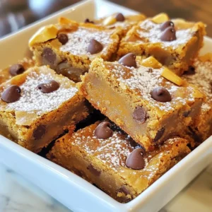 For these Peanut Butter Chocolate Chip Blondies, you need some simple ingredients. Each one adds to the rich flavor and texture of this treat. Here’s what you’ll need: - 1 cup creamy peanut butter - 1/2 cup packed brown sugar - 1/4 cup granulated sugar - 1/2 cup unsalted butter, softened - 1 large egg - 1 teaspoon pure vanilla extract - 1 cup all-purpose flour - 1/2 teaspoon baking soda - 1/4 teaspoon salt - 1 cup semi-sweet chocolate chips Each ingredient plays a key role. The creamy peanut butter gives a nutty base. The sugars add sweetness and moisture. Unsalted butter makes the blondies rich and soft. The egg binds everything together, while vanilla adds warmth. Flour provides structure, and baking soda helps them rise. Lastly, the chocolate chips offer bursts of sweetness. With these ingredients, you can create a delicious treat that everyone will love. {{ingredient_image_2}} Preheat your oven to 350°F (175°C). This step is key for even baking. Get a 9x9 inch baking pan ready. You can grease it with cooking spray or line it with parchment paper. Lining helps with easy removal later. In a large mixing bowl, add 1 cup of creamy peanut butter and 1/2 cup of softened unsalted butter. Next, pour in 1/2 cup of brown sugar and 1/4 cup of granulated sugar. Mix these ingredients until smooth. The blend should feel creamy and rich. Now, crack in 1 large egg. Add 1 teaspoon of pure vanilla extract. Beat the mixture well. You want the egg to blend fully until the mix is smooth and creamy. In a separate bowl, whisk together 1 cup of all-purpose flour, 1/2 teaspoon of baking soda, and 1/4 teaspoon of salt. Slowly add this dry mix to the wet ingredients. Stir gently until just combined. Be careful not to overmix; this keeps the blondies chewy. Take 1 cup of semi-sweet chocolate chips and fold them into the batter. Make sure they are evenly spread throughout. Use a gentle touch to avoid overworking the batter. Pour the batter into your prepared baking pan. Use a spatula to spread it evenly in the corners. Bake for 20-25 minutes. Check doneness by inserting a toothpick into the center. It should come out with a few moist crumbs. After baking, let the blondies cool in the pan for about 10-15 minutes. If you used parchment paper, lift them out carefully. Transfer to a wire rack to cool completely. Once cooled, cut into squares and enjoy! To get that perfect chewy bite, avoid overmixing. Mix the wet and dry ingredients until they just come together. If you mix too much, the blondies can turn out tough. I love to use a gentle folding motion when adding chocolate chips. This keeps the texture soft and inviting. How can you tell when your blondies are done? Look for golden edges and a soft top. Insert a toothpick into the center. If it comes out with a few moist crumbs, they are ready! If it’s wet, give them a few more minutes. Start checking around the 20-minute mark. For a lovely presentation, serve the blondies on a nice platter. A light dusting of powdered sugar can add charm. Drizzling melted chocolate on top makes them even more tempting. Cut them into squares and watch everyone smile! Pro Tips Use Room Temperature Ingredients: Ensure that your butter and egg are at room temperature before mixing. This helps create a smoother batter and ensures even baking. Don’t Overmix: When combining the dry and wet ingredients, mix just until combined to keep the blondies tender and chewy. Check for Doneness: Start checking the blondies at the 20-minute mark. They should be golden on the edges and slightly underbaked in the center for a gooey texture. Storage Tips: Store leftover blondies in an airtight container at room temperature for up to 3 days or refrigerate for longer freshness. {{image_4}} You can add nuts to your blondies for extra crunch. Chopped walnuts, pecans, or almonds work great. These nuts pair well with the sweet, rich flavors of the peanut butter and chocolate. You can also try different types of chocolate. Swap semi-sweet chocolate chips for dark or milk chocolate. Each choice adds a new twist to this treat. If you want a change from peanut butter, other nut butters can be fun. Almond butter or cashew butter offer a different taste. Sunflower seed butter is a great choice for nut-free options. Each butter will change the flavor and texture of the blondies. That way, you can keep things fresh and exciting! For gluten-free blondies, use a gluten-free flour blend. It keeps the texture light and tasty. You can also make these blondies vegan. Replace the egg with a flaxseed meal or applesauce. Use a vegan butter substitute, and you’re all set! These tweaks make the blondies accessible for everyone. You can store your blondies at room temperature. Place them in an airtight container. This keeps them soft and fresh. They stay good for up to 5 days. If you live in a warm place, consider refrigerating them. Just remember to let them come to room temp before enjoying. To keep blondies longer, freezing is best. Cut them into squares. Wrap each piece in plastic wrap tightly. Place the wrapped blondies in a freezer bag. They can last for up to three months in the freezer. When you want to enjoy them, just take them out and let them thaw. For the best taste, reheat your blondies in the oven. Preheat the oven to 350°F (175°C). Place the blondies on a baking sheet. Heat them for about 5 to 10 minutes. This warms them up and makes them soft again. You can also use the microwave if you need a quicker method. Just heat them for 10-15 seconds at a time. Enjoy your warm and gooey treat! Yes, you can use crunchy peanut butter. It adds texture and a nutty bite. However, it can change the blondie's smoothness. If you prefer a creamier texture, stick with creamy peanut butter. Crunchy may also affect how the blondies rise, making them slightly denser. To check for doneness, look for golden brown edges. Insert a toothpick in the center. If it comes out with a few moist crumbs, they are ready. Avoid overbaking, as this can dry them out. The center should be soft but not wet. Blondies stay fresh for about a week at room temperature. Store them in an airtight container to keep them moist. Signs of spoilage include a dry texture or off smell. If you need them to last longer, you can freeze them for up to three months. You learned how to make delicious blondies with simple ingredients and easy steps. Remember to mix wet and dry ingredients separately for the best texture. You can even try variations with nuts or different nut butters to suit your taste. Storage is easy, too, with tips for short- and long-term options. Whether fresh or frozen, these treats make everyone happy. Enjoy your baking and share your sweet results!