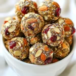 - 1 cup rolled oats - 1/2 cup creamy almond butter - 1/3 cup honey or pure maple syrup - 1/2 cup dried cranberries, roughly chopped - 1/2 cup slivered almonds - 1/4 cup chia seeds - 1 teaspoon vanilla extract - A pinch of sea salt The base of our energy bites starts with rolled oats. They add fiber and help keep you full. Next, we use creamy almond butter for healthy fats and protein. You can sweeten the bites with honey or pure maple syrup. Both options work well, so choose what you like best. Dried cranberries give a sweet and tangy flavor. They also add a nice chew to each bite. Slivered almonds bring a pleasant crunch, while chia seeds boost nutrition with omega-3s. A touch of vanilla extract enhances the flavor. Finally, a pinch of sea salt balances all the tastes. Each serving contains about 150 calories. The bites offer a balanced mix of macronutrients: around 20 grams of carbs, 5 grams of protein, and 7 grams of fat. These key ingredients provide many health benefits. Rolled oats aid digestion and help keep your heart healthy. Almond butter has protein and healthy fats, which support energy. Dried cranberries are rich in antioxidants, promoting good health. Chia seeds provide fiber and omega-3 fatty acids for brain health. These energy bites are more than tasty snacks; they are nutritious and satisfying! {{ingredient_image_2}} To start making your cranberry almond energy bites, gather your ingredients. In a large mixing bowl, mix these items: - 1 cup rolled oats - 1/2 cup creamy almond butter - 1/3 cup honey or pure maple syrup Stir them until they blend well and look smooth. Next, add more ingredients to the mix. Include: - 1/2 cup dried cranberries, roughly chopped - 1/2 cup slivered almonds - 1/4 cup chia seeds - 1 teaspoon vanilla extract - A pinch of sea salt Now, stir everything together until well combined. If the mixture feels sticky, add a bit more rolled oats. If it seems dry, mix in extra almond butter. This step helps you get the right texture. After mixing, it’s time to roll the mixture into balls. Use your hands to shape the mixture into small balls, each about 1 inch in diameter. This size is perfect for a single snack. Place these balls on a baking sheet lined with parchment paper. This will keep them from sticking. Next, chill the energy bites in the refrigerator for at least 30 minutes. Chilling is crucial because it helps the bites firm up. This way, they hold together better when you eat them. For serving, I suggest arranging the energy bites in a small decorative bowl. To make them look even better, sprinkle extra slivered almonds on top. This simple touch adds color and makes the bites more inviting. These tasty energy bites are great for a quick snack or a healthy treat after a workout. Enjoy the goodness! To keep your energy bites fresh, store them in an airtight container. Place them in the fridge. They will stay good for about a week. If you want to save them longer, freezing is a great option. To freeze, first, place the energy bites on a baking sheet. Make sure they are not touching each other. Freeze them for about an hour. Once firm, transfer them to a freezer-safe bag. This way, you can enjoy them for up to three months! Sometimes, mixtures can be too sticky or too dry. If your mixture feels sticky, add more rolled oats. Start with a tablespoon at a time. Mix well after each addition until the texture feels right. If it’s too dry, add a bit more almond butter. Again, start small. Just a teaspoon or two should do. This helps get that perfect, easy-to-roll texture. You can make these bites even more tasty! Try adding a dash of cinnamon or nutmeg for warmth. These spices add a nice touch. You can also add a few drops of almond extract for a stronger almond flavor. Another idea is to mix in dark chocolate chips or cocoa powder. This creates a rich, indulgent flavor. These simple changes can take your energy bites to the next level! Pro Tips Use Fresh Ingredients: Opt for the freshest dried cranberries and slivered almonds for enhanced flavor and texture in your energy bites. Experiment with Mix-ins: Feel free to customize your energy bites by adding other mix-ins like dark chocolate chips or pumpkin seeds for added variety and nutrition. Chill for Best Texture: Allowing the energy bites to chill longer than 30 minutes can help them firm up even more, making them less sticky and easier to handle. Storage Tips: For longer shelf life, consider freezing the energy bites; they can last up to 3 months in the freezer and can be enjoyed straight from the freezer for a cool treat. {{image_4}} You can switch up the nut butter in this recipe. If you have allergies, try sunflower seed butter or cashew butter. Each nut butter adds its unique flavor. You can also change the dried fruits. Use raisins, apricots, or even dried cherries for a twist. Different nuts like walnuts or pecans can also add a nice crunch. For a fun twist, try chocolate chip cranberry almond bites. Just mix in some dark chocolate chips with the rest of your ingredients. The chocolate will melt in your mouth with every bite. Another great idea is coconut-flavored energy bites. Add shredded coconut for a tropical flair. This will give your energy bites a chewy texture. If you want a vegan option, swap honey for pure maple syrup. This keeps your bites sweet while staying plant-based. For gluten-free energy bites, make sure to use certified gluten-free oats. This simple swap allows everyone to enjoy these tasty snacks. You can find many brands that sell cranberry almond energy bites. Popular options include RXBAR, LaraBar, and Nature Valley. These brands offer tasty bites with simple ingredients. When you compare these store-bought snacks to homemade ones, notice the differences. - Store-Bought: - Often higher in sugar. - May contain preservatives. - Convenient but can be costly. - Homemade: - You control the ingredients. - Lower in sugar and no preservatives. - Fresh and customizable to your taste. Making energy bites at home means you can enjoy them without unwanted extras. You can easily buy energy bites online. Websites like Amazon, Thrive Market, or even Target offer a wide range of options. They usually have good prices and fast delivery. If you prefer shopping in person, check your local health food stores. - Health Food Stores: - Often stock organic and natural snacks. - Good place to find unique brands. - Supermarkets: - Major chains usually have a health food aisle. - Look for the snack section for popular brands. Whether online or local, there are plenty of ways to find your favorite cranberry almond energy bites! These energy bites stay fresh in the fridge for about a week. To keep them tasty, store them in an airtight container. This method helps maintain their flavor and texture. If you want to keep them longer, consider freezing them. They can last for up to three months in the freezer. Just make sure to wrap them well before freezing. Yes, you can use other sweeteners. Maple syrup is a great option. It gives a similar sweetness and flavor. You might also try agave nectar or brown rice syrup. These alternatives work well and keep the energy bites yummy. Just remember to adjust the amount to match your taste. Absolutely! These energy bites are great for kids. They contain healthy oats, nuts, and fruit. These ingredients provide energy and nutrition. They are also easy to grab and eat. Just keep in mind any nut allergies. If nuts are a concern, you can swap almond butter for sun butter or another safe option. We explored how to make delicious cranberry almond energy bites. You learned about key ingredients, their nutritional benefits, and preparation steps. Storing tips help keep your bites fresh, while variations let you customize flavors. Remember, you can find pre-made options if needed. These bites are great for snacks and easy to share. Enjoy making them your own and boosting your energy with each tasty bite!
