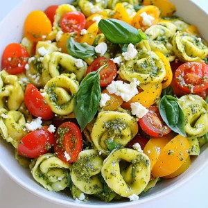 To make a vibrant pesto tortellini pasta salad, gather these simple ingredients: - 12 oz cheese tortellini - 1 cup cherry tomatoes, halved - 1 cup bell peppers, diced (a mix of colors adds fun) - 1 cup fresh spinach, roughly chopped - ½ cup black olives, pitted and sliced - ½ cup feta cheese, crumbled - ½ cup pesto sauce (homemade or store-bought) - 2 tablespoons extra virgin olive oil - Salt and freshly ground black pepper, to taste - Fresh basil leaves, for garnish Fresh pesto has a bright, rich flavor. It uses fresh basil, garlic, pine nuts, Parmesan, and olive oil. Making it at home allows for full control over the taste. I love to whip up a batch and store it for quick meals. Store-bought pesto is quick and easy. It still offers great taste but lacks the fresh zing of homemade. Choose what suits your time and taste best. Feel free to mix it up! Here are some ideas: - Swap cheese tortellini for a gluten-free version. - Try sun-dried tomatoes instead of fresh ones for a deeper flavor. - Use arugula or kale in place of spinach for a peppery bite. - Add grilled chicken or chickpeas for extra protein. - For a vegan option, replace feta with tofu or nutritional yeast. These swaps let you create a salad that fits your taste and dietary needs. {{ingredient_image_2}} Bring a large pot of salted water to a boil. Once boiling, add 12 oz of cheese tortellini. Cook them according to the package instructions, usually 5 to 7 minutes. You want them al dente, firm but tender. While the tortellini cooks, grab a large mixing bowl. Add 1 cup of halved cherry tomatoes, 1 cup of diced bell peppers, 1 cup of roughly chopped fresh spinach, and ½ cup of sliced black olives. Crumble ½ cup of feta cheese on top for added flavor. After draining the tortellini, rinse them under cold water to stop the cooking. Gently add the cooled tortellini to the bowl with the vegetables. Drizzle ½ cup of pesto sauce and 2 tablespoons of extra virgin olive oil over the mix. Season with salt and freshly ground black pepper to taste. Use a large spatula to toss the salad gently. Make sure everything is mixed well and the tortellini is coated in pesto. Cover the bowl and chill it in the fridge for at least 30 minutes. This lets the flavors blend. When ready to serve, give it a quick toss and garnish with fresh basil leaves for a nice touch. To cook tortellini just right, start with a large pot of salted water. Bring it to a boil. Add the tortellini and cook as the package says, usually 5-7 minutes. Check the texture; it should be firm but tender, known as al dente. Once cooked, drain the tortellini and rinse it under cold water. This stops the cooking process and keeps it from getting mushy. To elevate your pesto tortellini pasta salad, think about adding fresh herbs. Chopped parsley or dill can bring bright flavors. A squeeze of fresh lemon juice adds zing and balances the rich pesto. When seasoning, add salt and freshly ground black pepper carefully. Taste as you go to find the right balance. You can also mix in some red pepper flakes for a gentle heat. Presentation matters! Serve your salad in a big, shallow bowl. This way, everyone can see the colorful ingredients. Add a few whole basil leaves on top as a garnish. This not only looks nice but also adds extra flavor. You might also sprinkle some extra feta cheese for a creamy touch. A drizzle of olive oil over the top can make it shine and look fresh. Pro Tips Use Fresh Ingredients: Always opt for the freshest vegetables and herbs you can find. Fresh produce enhances the overall flavor of the salad and makes it more vibrant. Customize Your Pesto: If you have time, try making your own pesto with different nuts or herbs. This allows you to tailor the flavors to your liking and adds a personal touch. Let It Chill: Allowing the pasta salad to chill for at least 30 minutes before serving lets the flavors meld together, resulting in a tastier dish. Garnish for Presentation: Adding fresh basil leaves or a sprinkle of extra feta just before serving not only enhances the visual appeal but also adds a burst of flavor. {{image_4}} If you're looking for gluten-free choices, many brands offer gluten-free tortellini. These are usually made from rice or corn flour. Check your local store for options. You can also make your own using gluten-free flour blends. This way, you enjoy the same great taste without the gluten. To make this dish vegan, swap the cheese tortellini for a vegan version. You can find these at many grocery stores. For pesto, use a vegan brand or make your own without cheese. Blend basil, nuts, garlic, and olive oil for a tasty alternative. Also, replace feta cheese with tofu or a vegan feta for added texture. You can change ingredients based on the season. In summer, add sweet corn or zucchini. In fall, try roasted butternut squash or kale. Seasonal swaps keep the dish fresh and exciting. Plus, they enhance flavor and nutrition, making each bite a delight. To store leftover pesto tortellini pasta salad, place it in an airtight container. This keeps the salad fresh and safe. Make sure to press out any air before sealing. You can also cover the bowl with plastic wrap if you don’t have a container. Refrigerate the salad right after serving to maintain its flavor and texture. This salad is best served cold. If you want to enjoy it warm, gently reheat it on low heat. Make sure to stir often to avoid burning. You can also add a little olive oil if it feels dry. If you serve it cold, give it a quick toss to mix the flavors. This keeps the taste fresh and vibrant. When stored properly, pesto tortellini salad lasts about 3-5 days in the fridge. The tortellini and vegetables stay good for a while, but the feta and pesto may lose flavor over time. If you use homemade pesto, it could last about a week in the fridge. Always check for any signs of spoilage before eating. Yes, you can make this salad ahead of time. It tastes even better after chilling in the fridge. I suggest you prepare it a few hours before serving. This allows the flavors to blend well. Just make sure to cover it tightly to keep it fresh. For this recipe, I recommend using basil pesto. It adds a fresh and bright flavor. You can use store-bought pesto for convenience. Homemade pesto also works great if you want a personal touch. Just make sure it’s smooth and flavorful. To prevent the tortellini from sticking, rinse them under cold water after cooking. This cools them down and stops cooking. Tossing them with a little olive oil can also help. Make sure to separate any that stick together gently. Absolutely! If you want to switch things up, try using mozzarella or goat cheese. Both add a nice flavor and texture. Just remember to crumble or slice them into small pieces. This helps blend their taste with the other ingredients. This blog post covered all you need for a great tortellini salad. We talked about choosing fresh or store-bought pesto, customizing your dish with alternative ingredients, and step-by-step cooking instructions. You now have tips for perfect tortellini and serving ideas. Plus, we looked at gluten-free and vegan options, storage tips, and answered common questions. Remember, this salad is easy to make and fun to customize. Enjoy your cooking adventure!