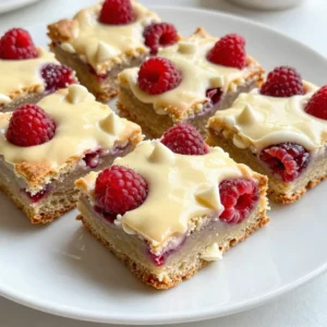 - 1 cup unsalted butter, melted - 1 cup packed brown sugar - 1/2 cup granulated sugar - 2 large eggs - 2 teaspoons vanilla extract - 2 cups all-purpose flour - 1 teaspoon baking powder - 1/2 teaspoon salt - 1 cup white chocolate chips - 1 cup fresh raspberries You need precise amounts for each ingredient to get the best results. Here are the measurements: - 1 cup unsalted butter (melted) - 1 cup packed brown sugar - 1/2 cup granulated sugar - 2 large eggs - 2 teaspoons vanilla extract - 2 cups all-purpose flour - 1 teaspoon baking powder - 1/2 teaspoon salt - 1 cup white chocolate chips - 1 cup fresh raspberries You can swap some ingredients if needed. For butter, use coconut oil or margarine. For sugar, try coconut sugar or honey. If you cannot find fresh raspberries, frozen ones work too. Just make sure to thaw and drain them well before adding. This way, you can still enjoy these blondies! {{ingredient_image_2}} First, you need to preheat your oven to 350°F (175°C). This step is key to getting that perfect bake. Next, grab an 8x8-inch square baking pan. You can grease it lightly or line it with parchment paper. This helps with easy removal later. In a large mixing bowl, combine the melted butter, packed brown sugar, and granulated sugar. Use a whisk to blend them until smooth and creamy. Add the eggs, one by one. Mix well after each egg. Then stir in the vanilla extract. This adds a nice flavor. In another bowl, sift together the all-purpose flour, baking powder, and salt. Gradually add this dry mix to your wet mix. Stir gently until just combined; do not overmix. You want a thick batter. Now, gently fold in the white chocolate chips and fresh raspberries. Be careful not to break the raspberries too much. You want some whole pieces for bursts of flavor. Pour the batter into the prepared baking pan. Use a spatula to spread it evenly. Place the pan in your preheated oven. Bake for 25-30 minutes. The edges should turn lightly golden. A toothpick inserted in the center should come out with a few moist crumbs. Once baked, remove the pan from the oven. Let the blondies cool in the pan for about 10 minutes. This helps them set before you take them out. Carefully lift them out using the parchment paper if you used it. Place them on a wire rack to cool completely. After they cool, cut into squares of your desired size. Enjoy these delicious treats! To get the best texture for your blondies, start with room temperature ingredients. This helps them mix well. Be careful not to overmix the batter. Stir until it is just combined. A thick batter gives a great chewy texture. Bake until the edges are golden. Use a toothpick to check; it should come out with a few moist crumbs. Store your blondies in an airtight container. This keeps them fresh for up to a week. If you want them to last longer, consider freezing them. Wrap each blondie in plastic wrap. Then, place them in a freezer bag. They can stay good for up to three months when frozen. For a lovely presentation, dust the blondies with powdered sugar. You can also add a scoop of vanilla ice cream. Whipped cream on the side makes it even better. Serve with fresh raspberries for a colorful touch. This adds a nice pop of flavor and color to your dessert spread. Pro Tips Use Room Temperature Eggs: Allow your eggs to come to room temperature before adding them to the batter. This helps achieve a smoother blend and better rise in your blondies. Don’t Overmix the Batter: Gently fold the dry ingredients into the wet mixture until just combined. Overmixing can lead to dense blondies, so be careful! Try Different Mix-Ins: Feel free to experiment by adding nuts, coconut, or different types of chocolate chips. Customize your blondies to suit your taste! Cool Completely Before Cutting: Allow the blondies to cool completely before slicing. This ensures cleaner cuts and helps the blondies set properly. {{image_4}} You can change the taste of your blondies easily. Adding nuts adds a nice crunch. Try chopped walnuts or pecans for a rich flavor. You can also swap raspberries for other fruits. Cherries or blueberries work well too. They will give a new twist to the recipe. If you need gluten-free blondies, use gluten-free flour. It works just like all-purpose flour. For a vegan option, replace the eggs with flax eggs. Mix one tablespoon of flaxseed meal with three tablespoons of water. Let it sit for five minutes to thicken. You can also use coconut oil instead of butter. Seasonal fruits can change the vibe of your blondies. In spring, use strawberries or fresh peaches. In fall, add pumpkin puree or apples for warmth. Top them with crushed candy canes in winter for a festive touch. These variations keep your blondies fresh and fun! To keep your white chocolate raspberry blondies fresh, store them in an airtight container. This method locks in moisture and flavor. Place parchment paper between layers if stacking. Keep them at room temperature for the best taste and texture. Avoid placing them in direct sunlight or near heat sources. If you want to save some for later, freezing is a great option. First, let the blondies cool completely. Then, cut them into squares. Wrap each piece tightly in plastic wrap. Place the wrapped blondies in a freezer-safe bag or container. Label the bag with the date. They can last in the freezer for up to three months. At room temperature, blondies stay fresh for about 3-4 days. If you refrigerate them, they can last up to a week. Just remember that refrigeration can change their texture, making them a bit denser. Enjoy them at room temperature for the best experience! What can I substitute for white chocolate? If you don’t have white chocolate, you can use butterscotch chips or vanilla chips. These options give a sweet flavor similar to white chocolate. You can also use a mix of milk chocolate and vanilla extract for a twist. Just remember, the taste will change slightly, but they will still be delicious! How do I know when the blondies are done? You will know the blondies are ready when the edges turn lightly golden. A toothpick inserted in the center should come out with a few moist crumbs. If it comes out clean, they may be overdone. Keep an eye on them, as ovens can vary in heat! Can I use frozen raspberries? Yes, you can use frozen raspberries in your blondies. Just be sure to add them straight from the freezer. If they thaw too much, they may break apart and turn the batter pink. The flavor will still be great, so don’t worry! This blog explained how to make delicious blondies. We covered every ingredient, from butter to sugar, and gave you measurement details. I shared helpful tips for mixing and baking to get the best texture. You learned how to store them properly and even freeze them for later. Plus, we explored fun variations and answered common questions. Remember, you can always switch ingredients or try new flavors. Baking blondies is a fun adventure, and with these steps, you can enjoy tasty treats anytime!