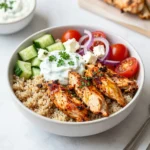 - Chicken breast and marinade components - 1 lb chicken breast, cut into strips - 2 tablespoons extra virgin olive oil - 2 teaspoons dried oregano - 1 teaspoon garlic powder - 1 teaspoon smoked paprika - Salt and freshly ground black pepper to taste The chicken breast is the star of this dish. I use fresh chicken to keep it juicy. The olive oil helps the spices stick and adds flavor. Oregano gives a nice herbal taste. Garlic powder and smoked paprika add depth. Lastly, salt and pepper enhance all the flavors. - Fresh vegetables and toppings - 1 medium cucumber, diced - 1 cup cherry tomatoes, halved - 1 small red onion, thinly sliced - ½ cup feta cheese, crumbled - ½ cup tzatziki sauce (store-bought or homemade) - Fresh parsley, chopped (for garnish) Fresh vegetables are key for crunch and color. The diced cucumber adds crispness. Cherry tomatoes bring sweetness, and red onion adds a bit of bite. Toppings like feta cheese and tzatziki sauce add creamy and tangy notes. Don’t forget the parsley for a fresh touch. - Grains (quinoa or rice) - 1 cup cooked quinoa or rice (your choice) I like to use quinoa for its nutty flavor and texture. Rice is another great option. Both grains serve as a hearty base and soak up the sauce well. You can choose what you prefer or have on hand. {{ingredient_image_2}} To start, I mix the marinade ingredients in a large bowl. I add 2 tablespoons of extra virgin olive oil, 2 teaspoons of dried oregano, 1 teaspoon of garlic powder, and 1 teaspoon of smoked paprika. Next, I add a pinch of salt and black pepper. This mix smells fantastic! Once the marinade is ready, I toss in the 1 pound of chicken breast strips. I coat the chicken well, ensuring every piece gets that flavorful blend. I let it sit for a few minutes to soak up the tastes. Now, I heat a non-stick skillet over medium-high heat. When the skillet is hot, I add the marinated chicken strips. I sauté them for about 6 to 8 minutes, stirring occasionally. I look for that perfect golden color. When the chicken is cooked through, I take it off the heat. While the chicken cooks, I prepare the fresh vegetables. In a medium bowl, I combine a diced medium cucumber, 1 cup of halved cherry tomatoes, and 1 small thinly sliced red onion. I sprinkle a pinch of salt over the veggies and stir them well. This step helps the flavors mix nicely. To assemble my gyro bowls, I start with a base of cooked quinoa or rice. I use about 1 cup for each bowl. Next, I layer the sautéed chicken strips on top. Then, I add the fresh vegetable mix. I love the colors in this bowl! I sprinkle ½ cup of crumbled feta cheese over everything. For the finishing touch, I drizzle on ½ cup of tzatziki sauce. This creamy sauce adds a nice tang. I like to garnish with chopped fresh parsley to make it look bright and fresh. To make the chicken tasty, marinate it well. Use olive oil, oregano, garlic powder, and smoked paprika. Mix these in a bowl, then add a good pinch of salt and pepper. Coat the chicken strips fully in the marinade. Let the chicken sit for at least 30 minutes. This helps the flavors soak in. When cooking, heat your skillet to medium-high. Add the marinated chicken strips, and cook them for about 6-8 minutes. Stir them occasionally. Look for a nice golden brown color. This shows they are ready and cooked through. Use fresh herbs to boost flavor. I love adding more oregano or fresh parsley on top. You can also try adding dill for a bright taste. For a spicy kick, sprinkle some crushed red pepper flakes. These will wake up your taste buds! For a beautiful bowl, use a rustic wooden platter. This lets each food shine on its own. Start with a base of quinoa or rice. Then add the chicken and fresh veggies. Finish with crumbled feta cheese and a drizzle of tzatziki sauce. Don’t forget lemon wedges! They add a zesty touch. Place them on the side for a bright pop of color. This makes your dish not only tasty but also pleasing to the eye. Pro Tips Marinate the Chicken: For even more flavor, allow the chicken to marinate for at least 30 minutes, or up to overnight in the refrigerator. This enhances the taste and tenderness of the meat. Customize Your Bowl: Feel free to add or substitute any vegetables you like. Bell peppers, olives, or even avocado can make delicious additions to your gyro bowl. Make Your Own Tzatziki: If you have the time, try making homemade tzatziki sauce with Greek yogurt, grated cucumber, garlic, and dill for a fresh and tangy flavor. Perfectly Cooked Chicken: To ensure the chicken is cooked throughout without drying out, use a meat thermometer; the internal temperature should reach 165°F (75°C). {{image_4}} For a vegetarian option, you can use chickpeas or tofu as your protein source. Both options soak up flavor well. If you prefer a vegan dish, choose tofu or tempeh. For a dairy-free tzatziki, you can blend coconut yogurt with cucumber and lemon juice. This keeps the creaminess without the dairy. Besides quinoa or rice, you can use barley or farro for a different texture. These grains add a nutty flavor. If you're looking for gluten-free alternatives, try using millet or cauliflower rice. Both choices are light and will complement your gyro bowl well. To give your gyro bowls a twist, add sauces like tahini or harissa. These sauces bring new layers of taste. You can also sprinkle in spices like cumin or coriander for more depth. These simple changes can elevate your meal and keep it exciting! To store leftovers, place them in airtight containers. Make sure to cool the food first. You can keep the Greek Chicken Gyro Bowls in the fridge for up to three days. Storing components separately helps keep everything fresh. Keep the tzatziki sauce in a separate container to avoid sogginess. When you want to reheat, use a microwave or a skillet. If using a microwave, heat in short bursts to avoid overcooking. For the skillet, warm on low heat until hot. Stir occasionally to make sure the chicken stays juicy and the veggies don’t get too soft. For freezing, store the chicken and grains separately. Place them in freezer-safe bags or containers. This helps preserve taste and texture. You can freeze the chicken for up to three months. When you're ready to eat, thaw in the fridge overnight. Reheat thoroughly before serving. A Gyro Bowl is a tasty dish inspired by the classic Greek gyro. It has layers of flavorful ingredients. The main parts include seasoned chicken, fresh veggies, grains, and a creamy sauce. You can customize it to fit your tastes. Yes, you can make this recipe ahead. I suggest marinating the chicken a day before. This makes the flavors stronger. You can also chop the veggies in advance. Store them in the fridge until you are ready to cook. Cooked chicken and grains can last in the fridge for three to four days. If you need a substitute for tzatziki sauce, try Greek yogurt with herbs. You can mix yogurt with garlic, lemon juice, and dill. Hummus is another great option. It adds creaminess and flavor. You can also use a simple vinaigrette for a lighter touch. To boost the chicken's flavor, marinate it longer. Use olive oil, oregano, garlic powder, and smoked paprika. You can add lemon juice for a zesty kick. Try other spices like cumin or coriander for extra depth. This will make your gyro bowls even tastier! This blog post covered how to make delicious Gyro Bowls. You learned about key ingredients, from chicken to fresh vegetables. I provided clear steps for marinade preparation, cooking, and assembling. Tips and tricks helped you perfect the dish while considering variations for different diets. Remember, storing and reheating properly keeps meals fresh. I hope these insights inspire you to create your own tasty Gyro Bowls! Enjoy making and sharing this dish with friends and family.